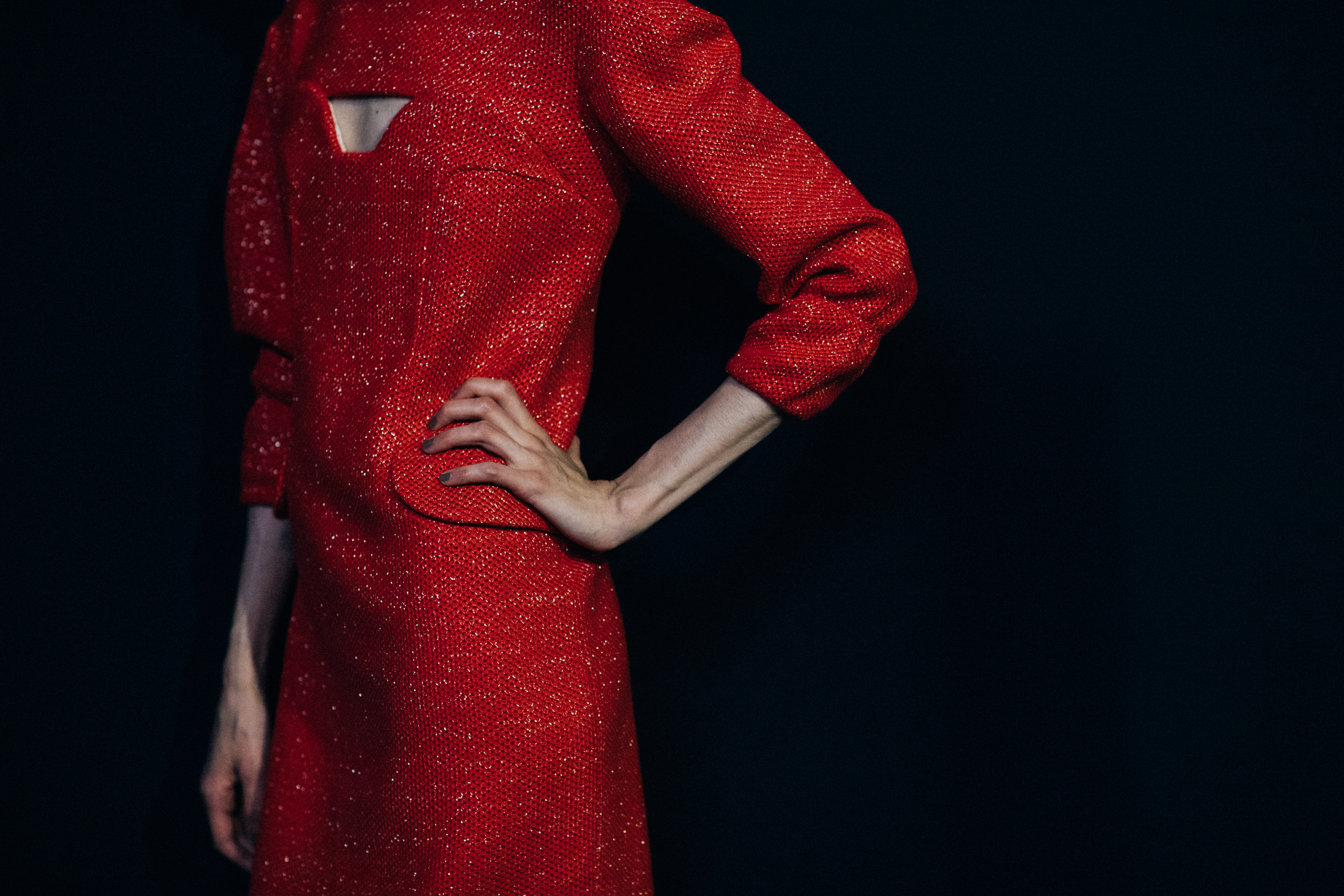 Model wearing red couture dress