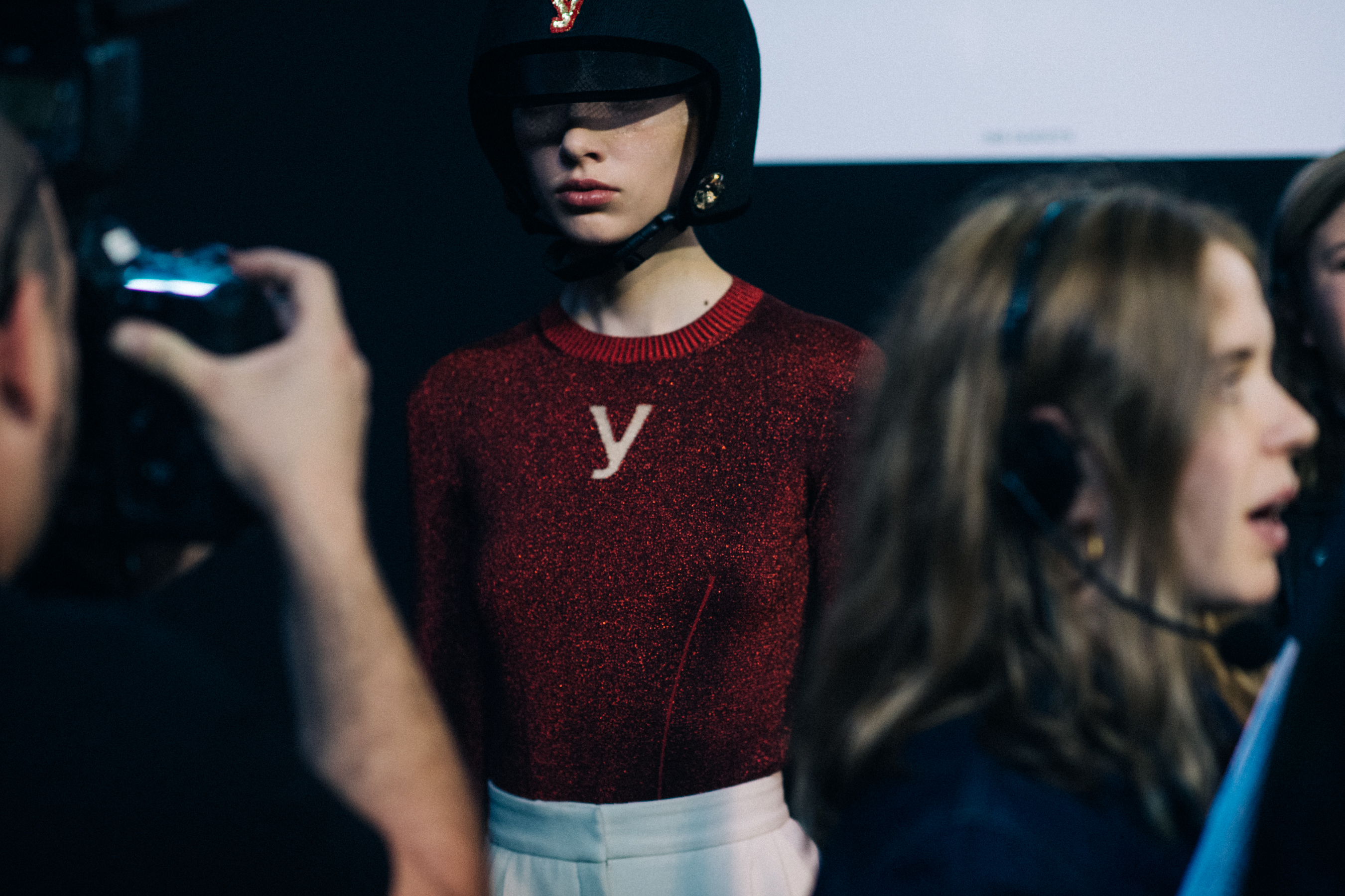 Model wearing red sweater and helmet