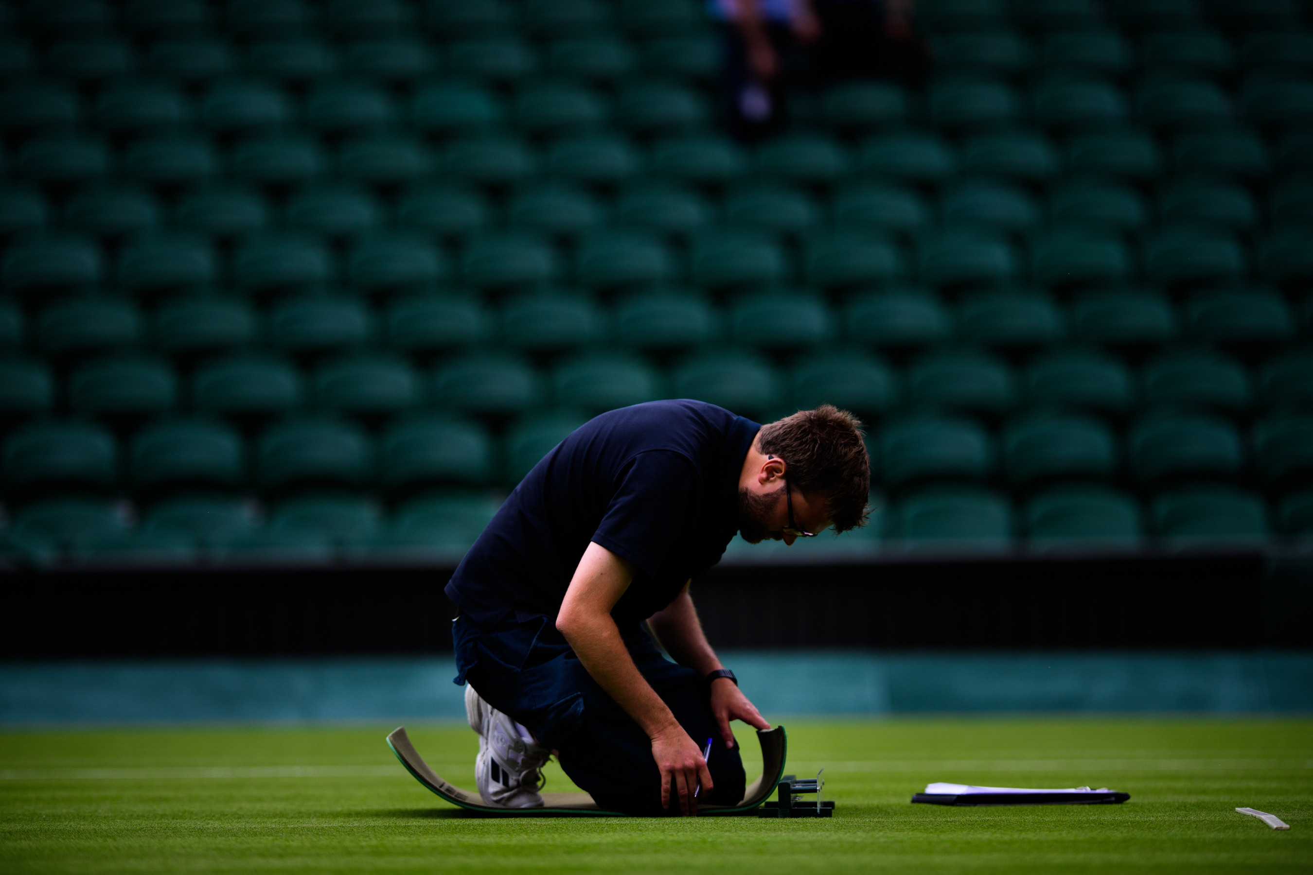 Man working on tennis court