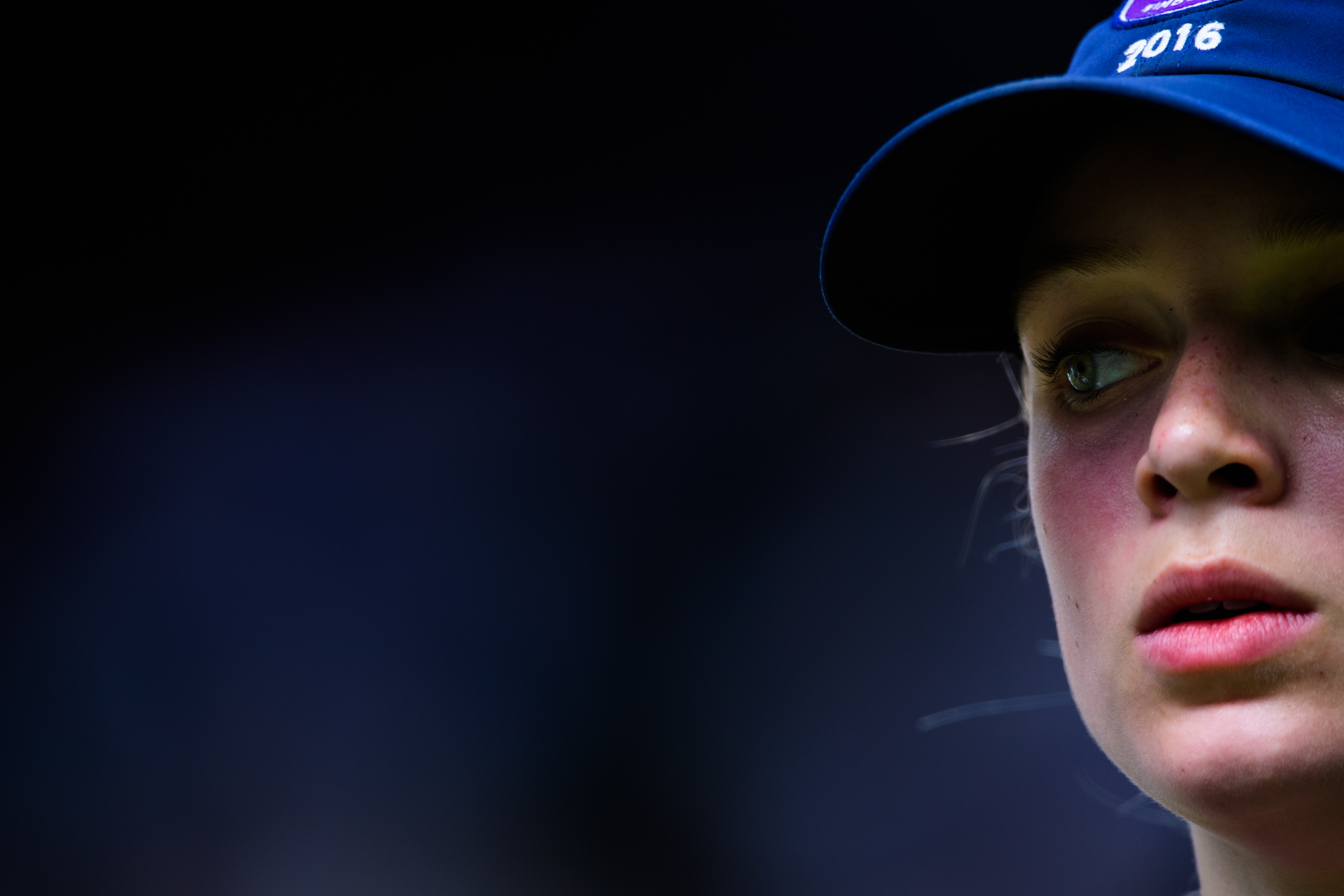 Girl wearing blue tourament staff hat