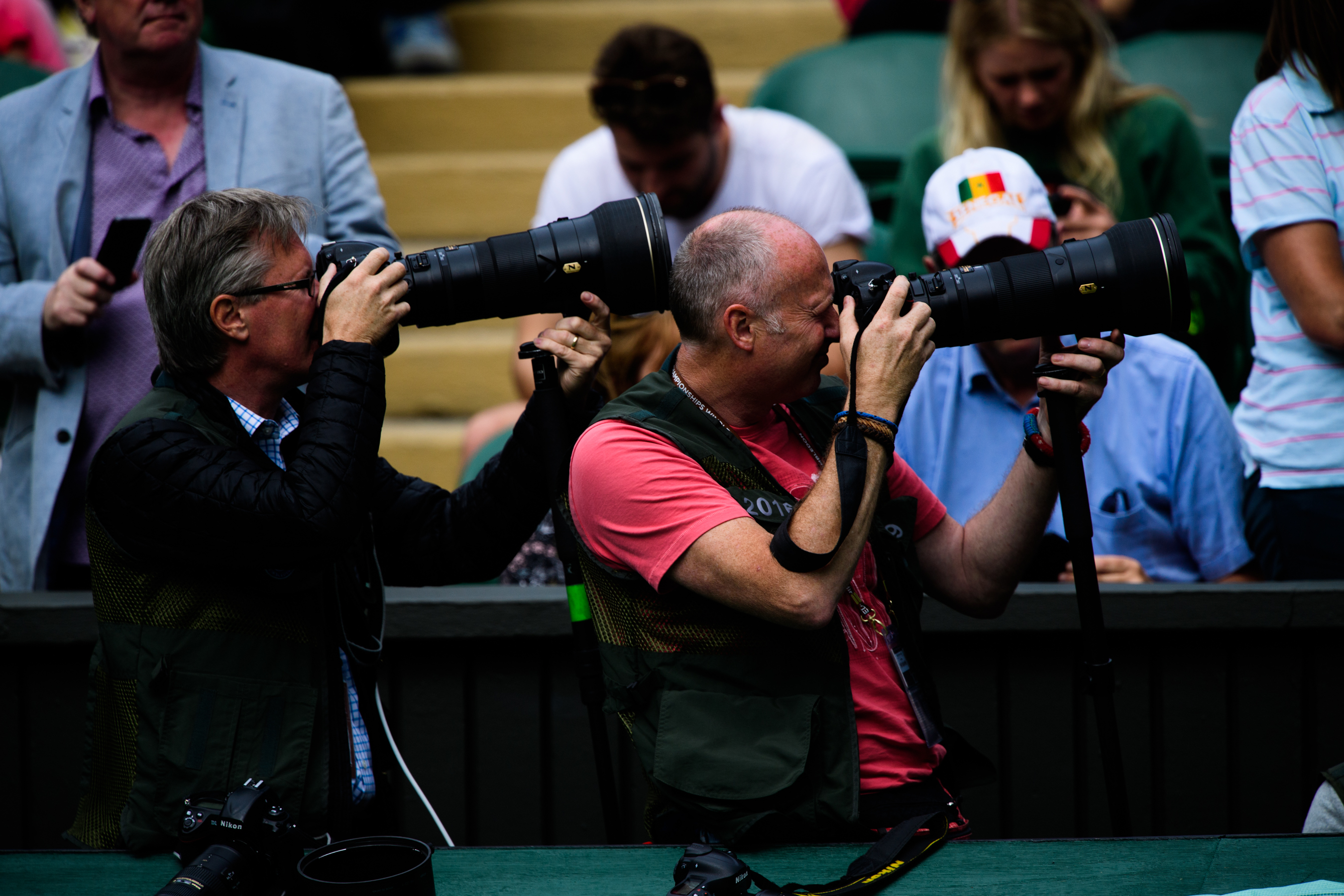 Two photographers with telephoto lenses