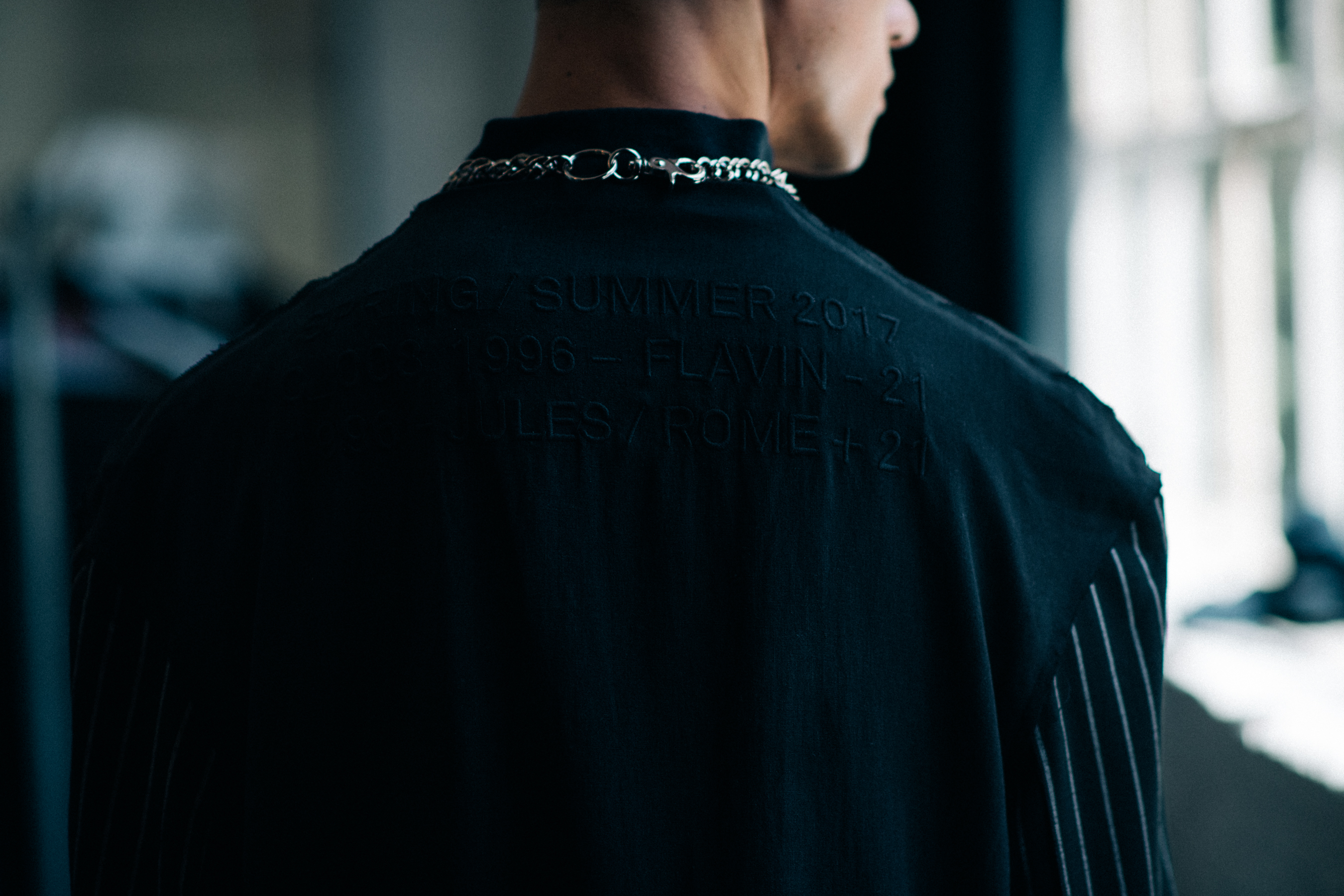 Male model wearing chain and black