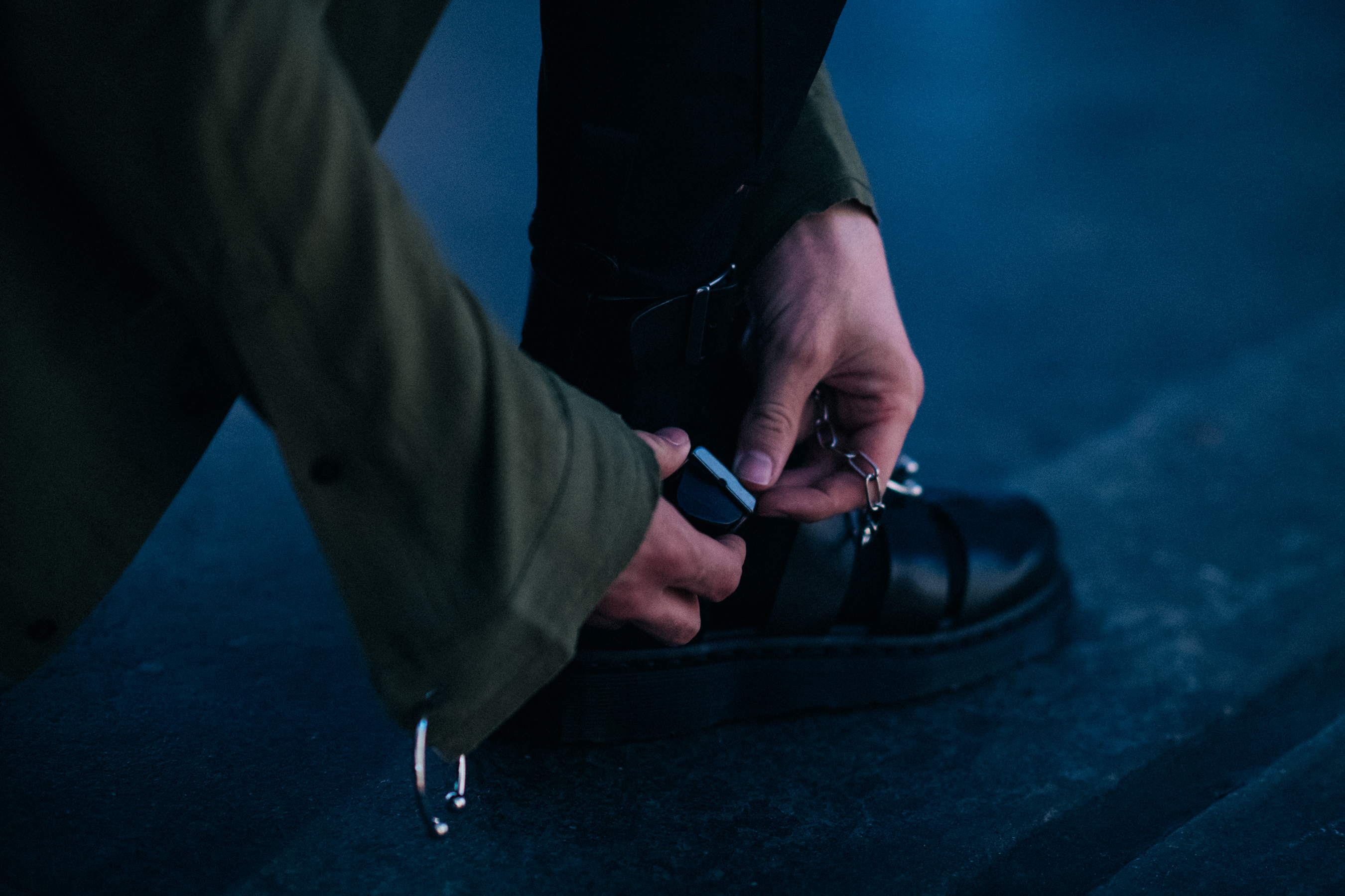 Male model fixing black leather shoe
