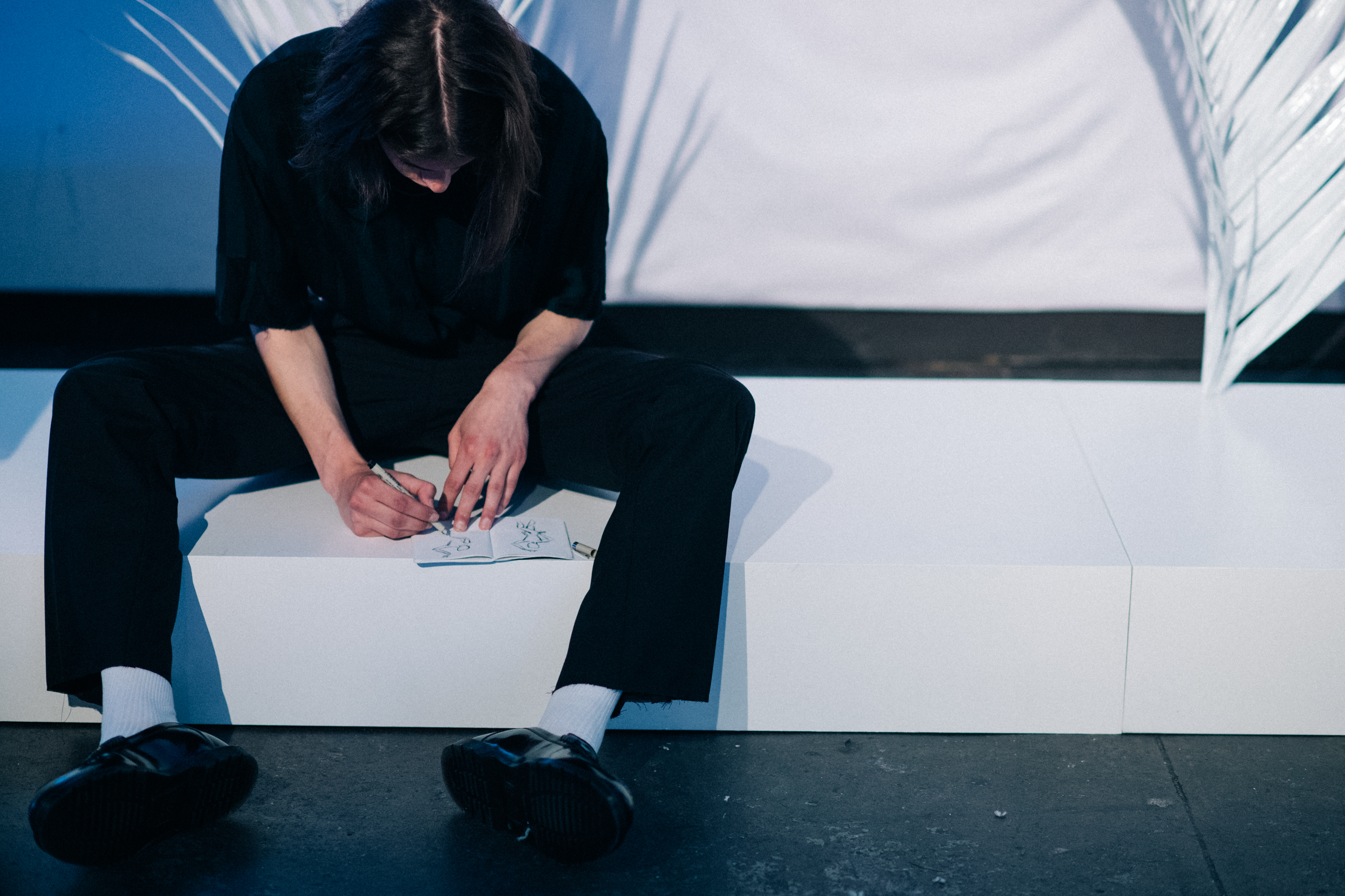 Male model drawing before show
