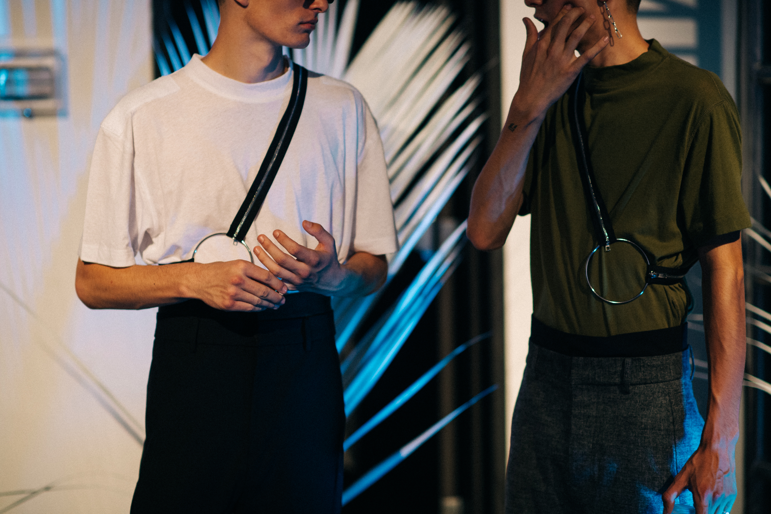 Two male models wearing chest belts