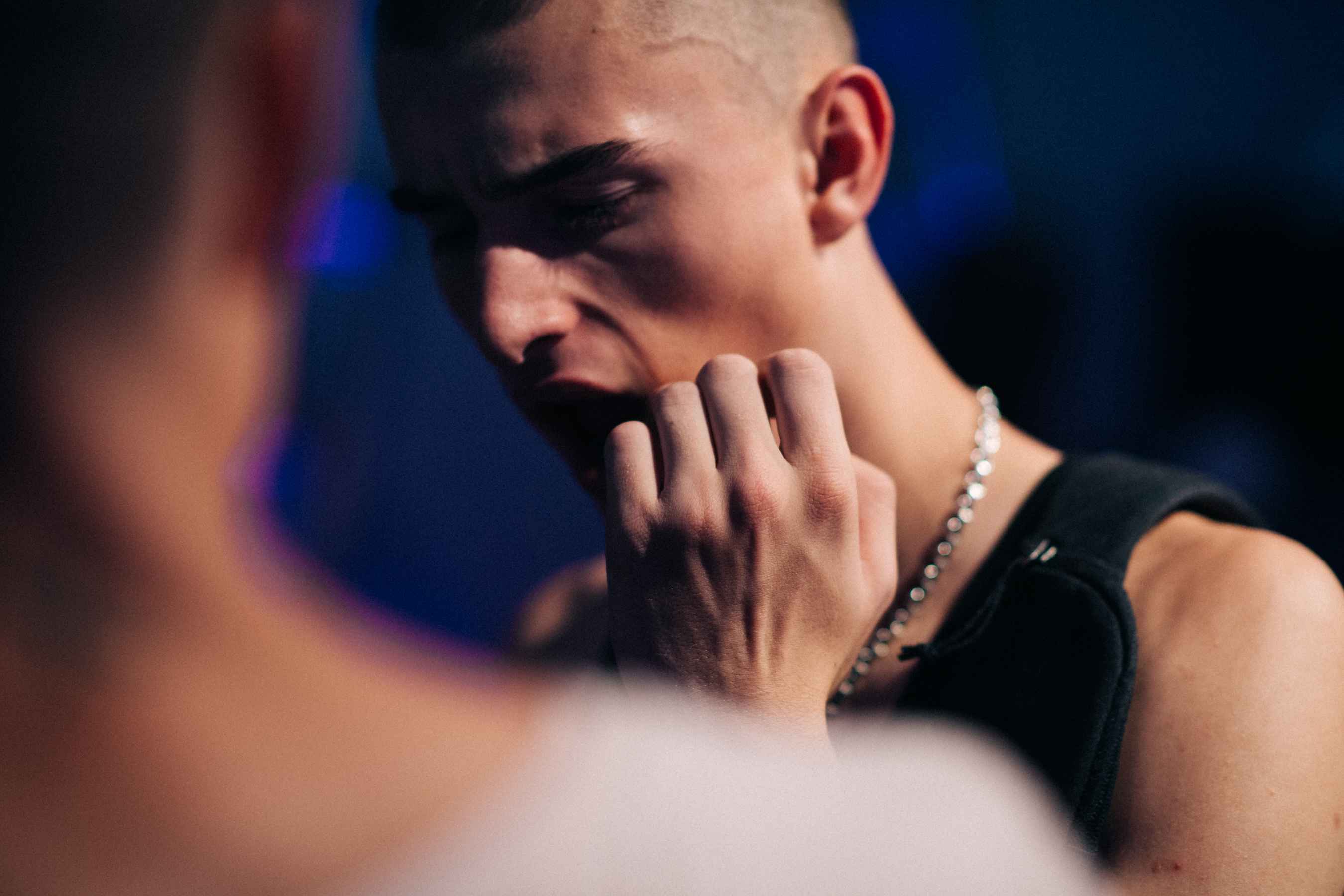 Male model scratching his face