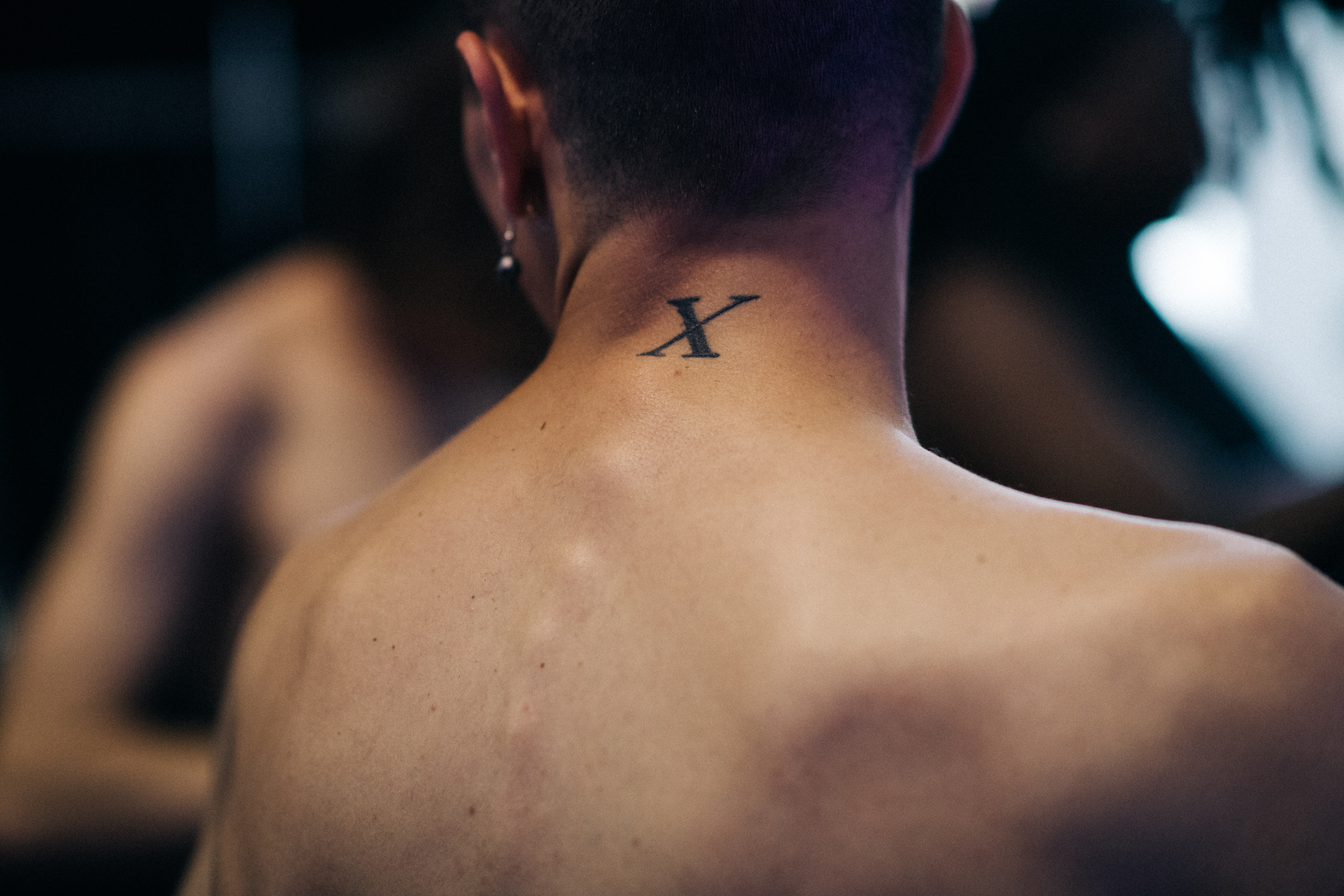 Male model with tattoo X