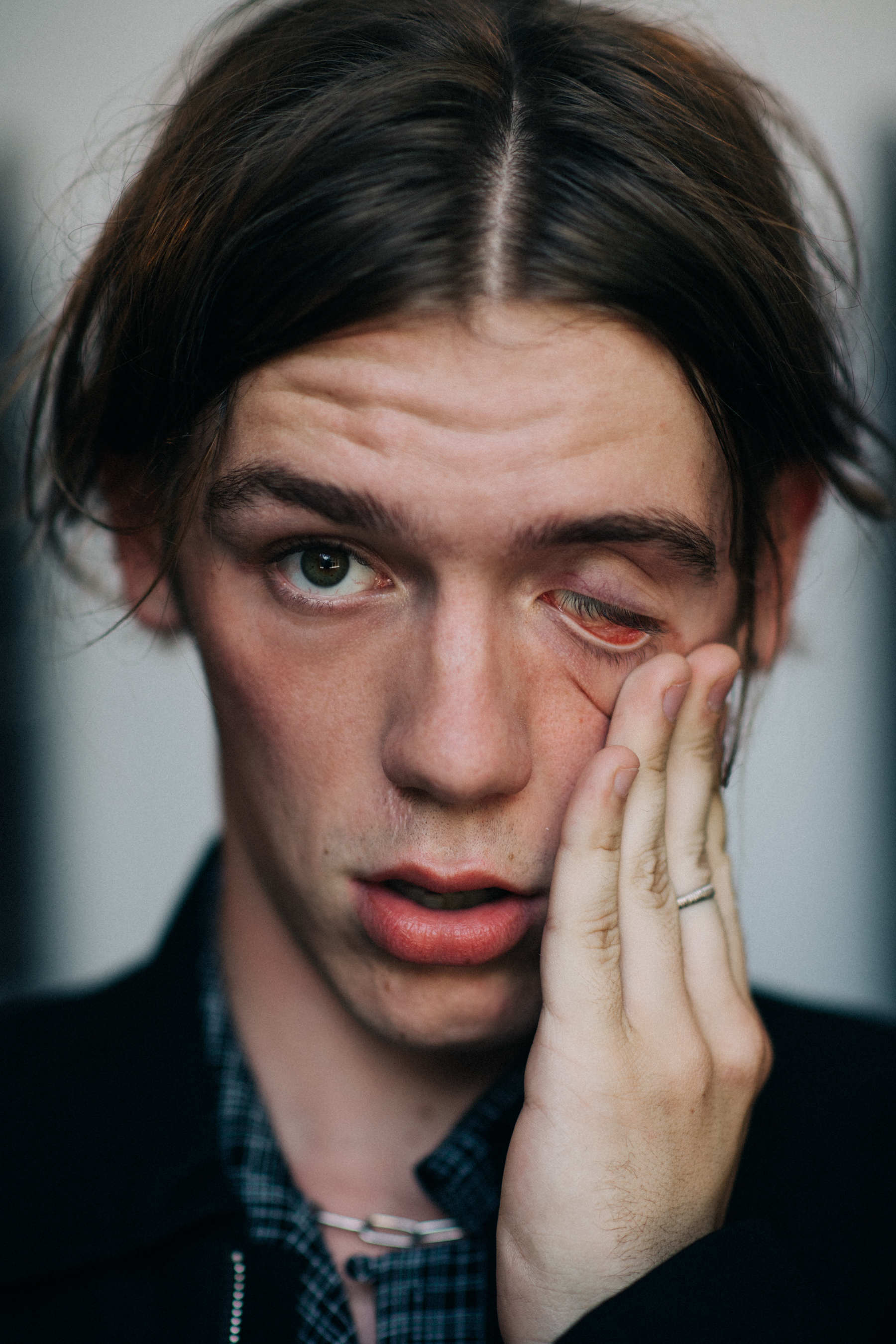Portrait of male model touching face