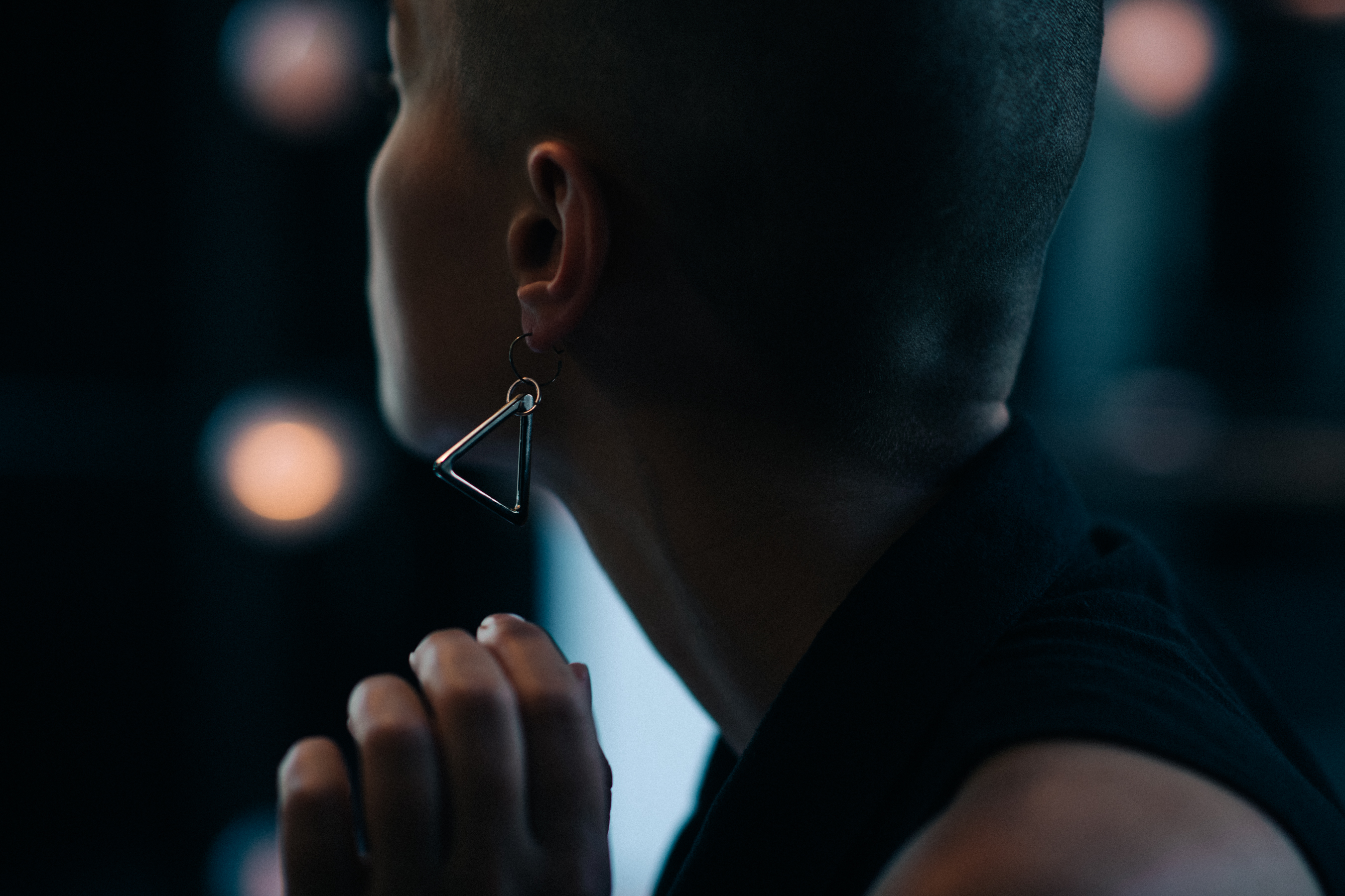 Model with shaved head and earring