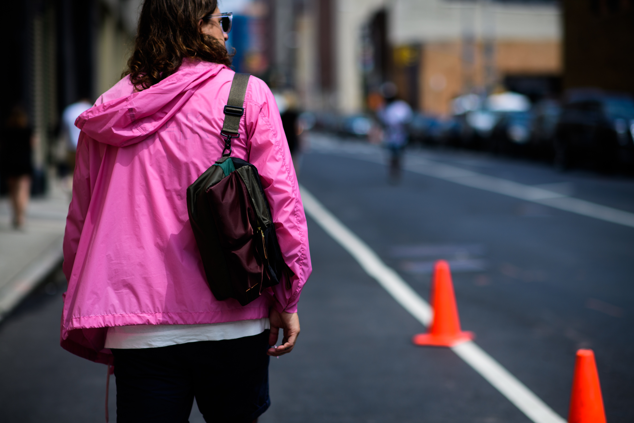 Menswear buyer wearing pink windbreaker