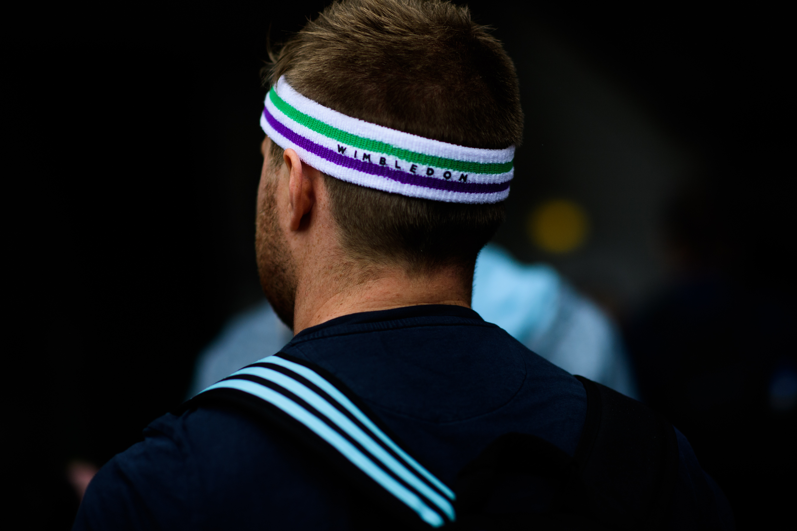 Man wearing headband with tournament name