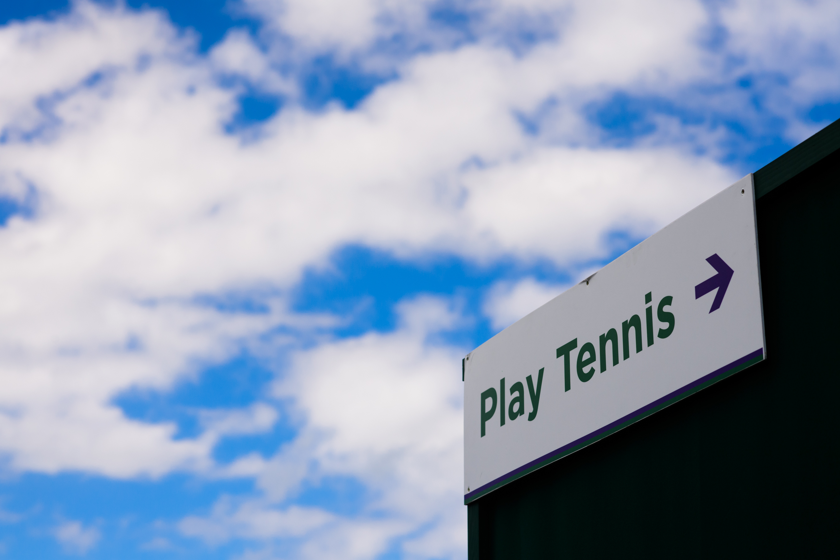 Play Tennis sign and blue sky