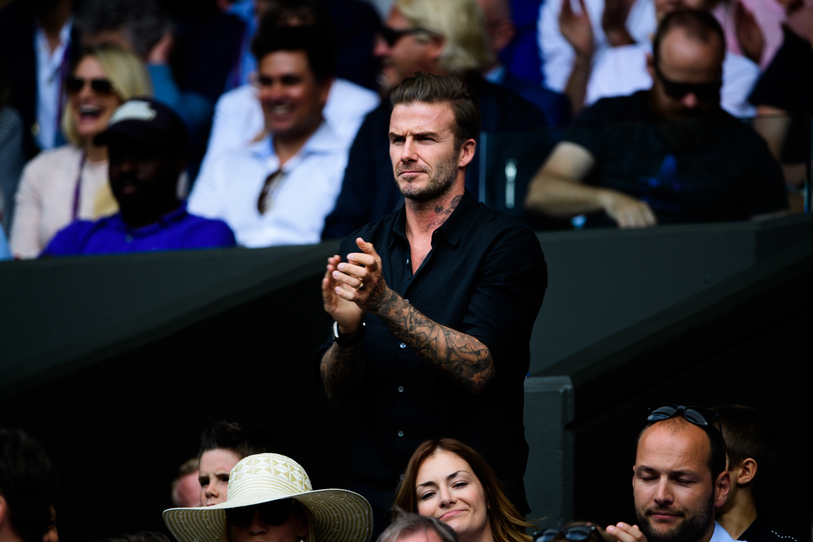 Famous British football player watching tennis