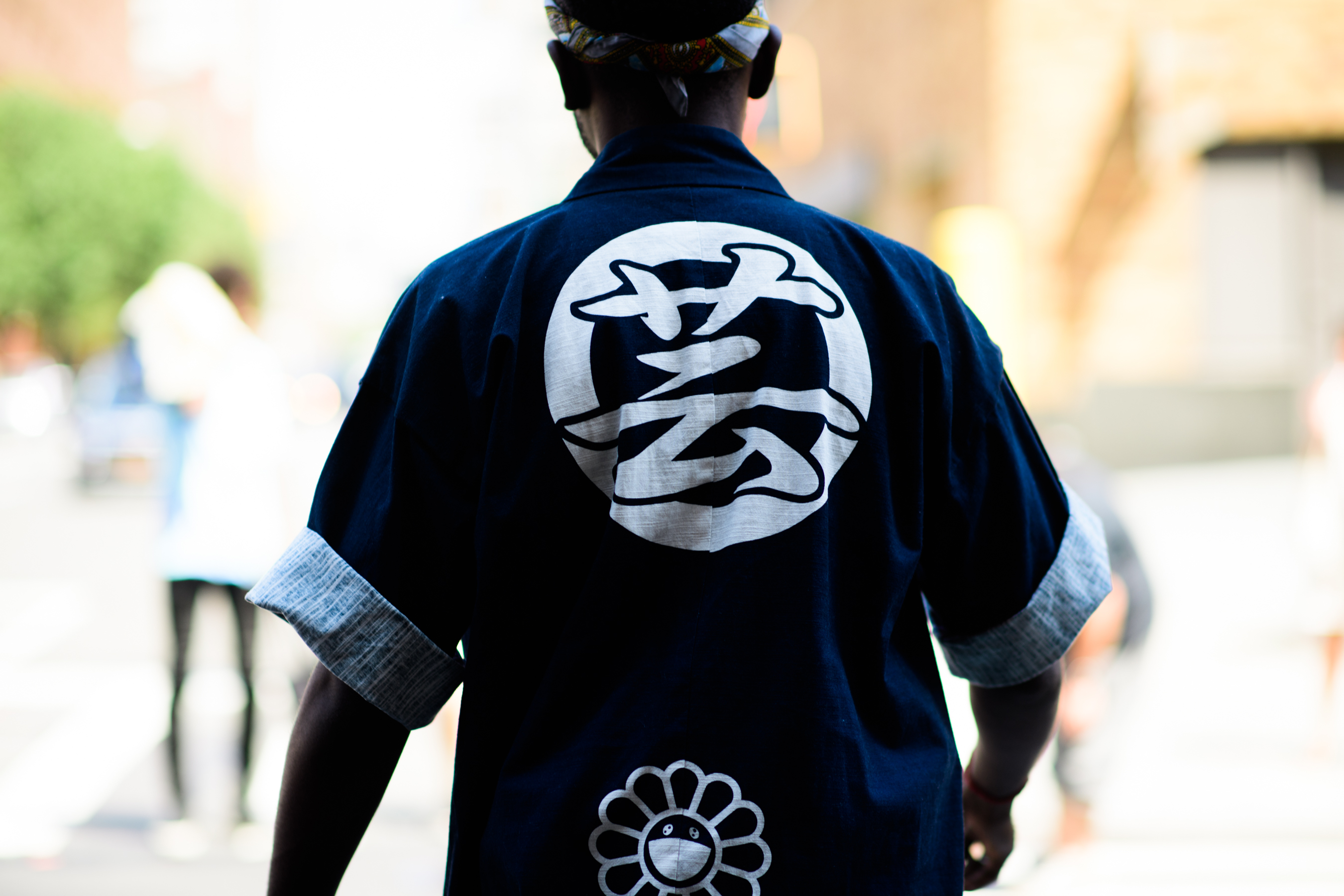 Man wearing blue kimono style shirt