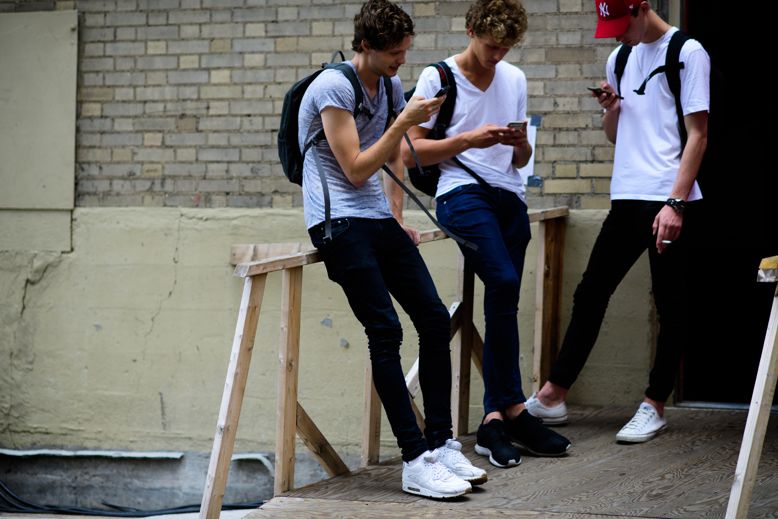 Three male models after the show