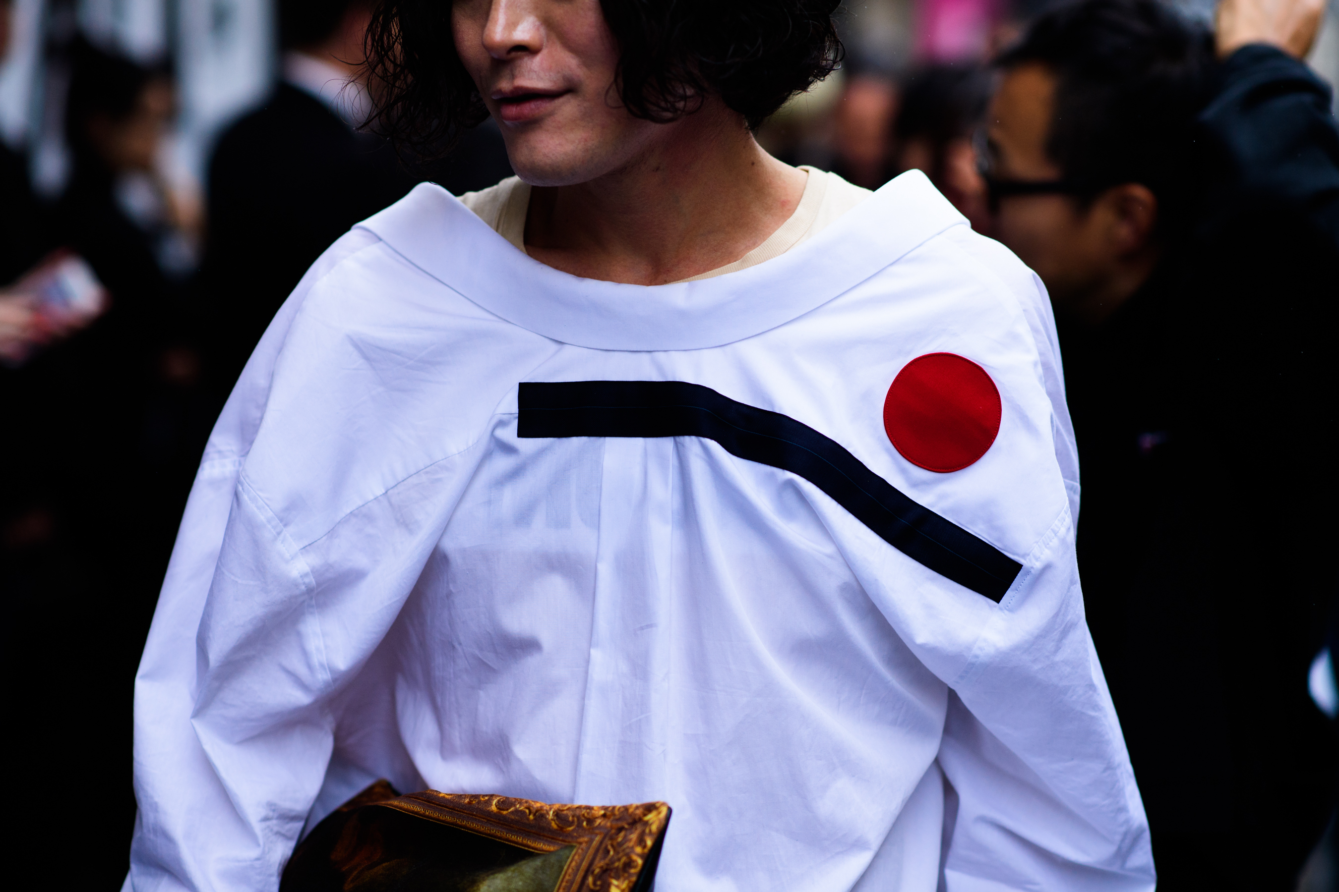 Asian man wearing white coat