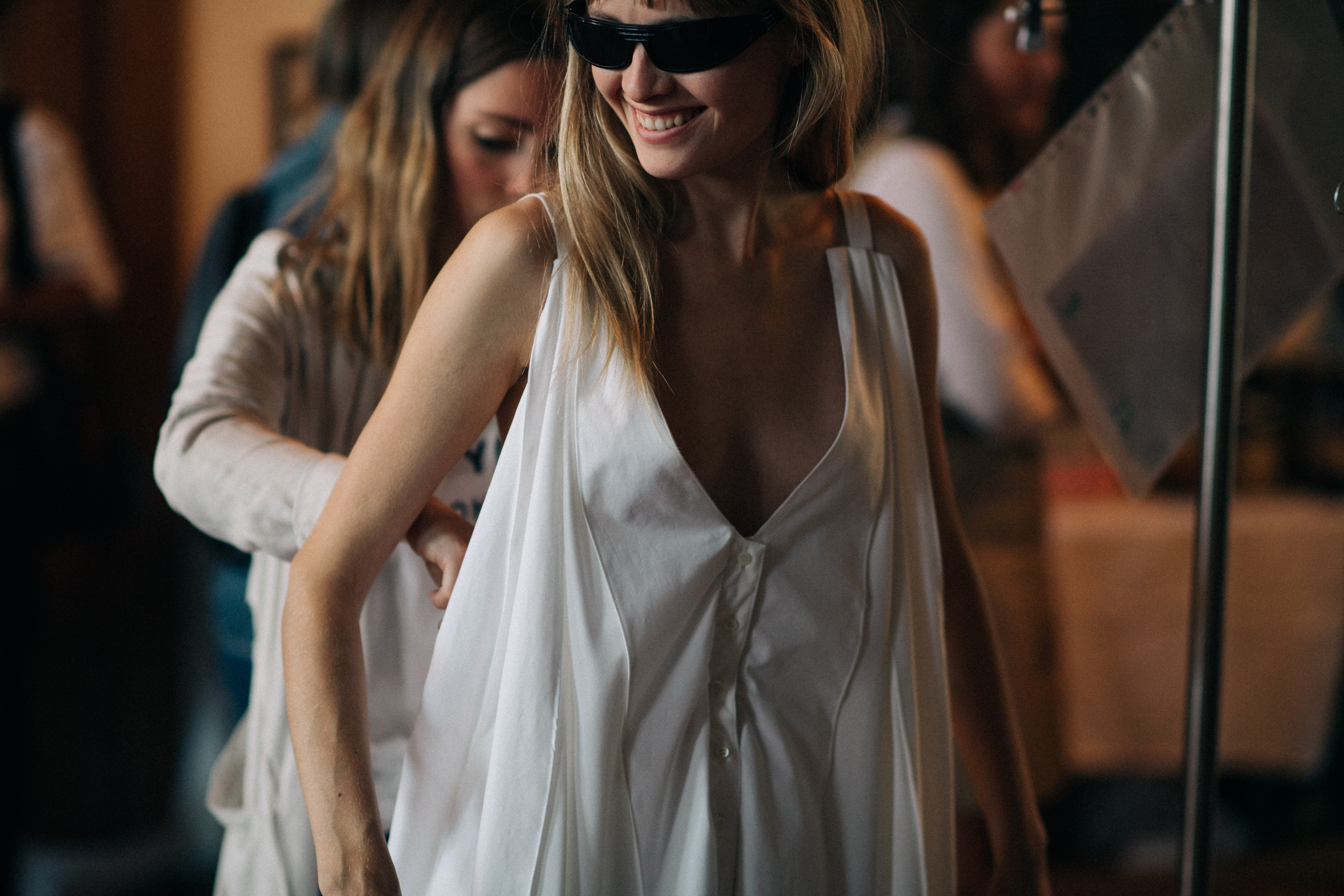 Model wearing white dress before the show