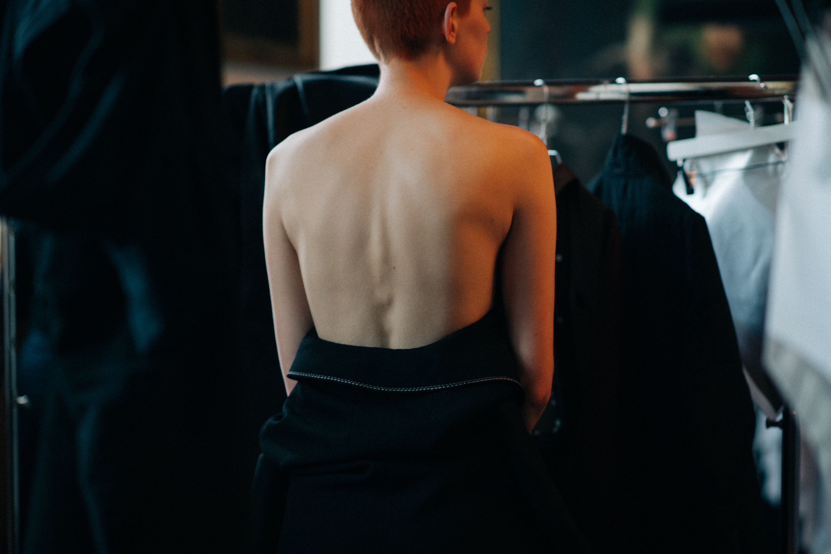 Model wearing open back garment