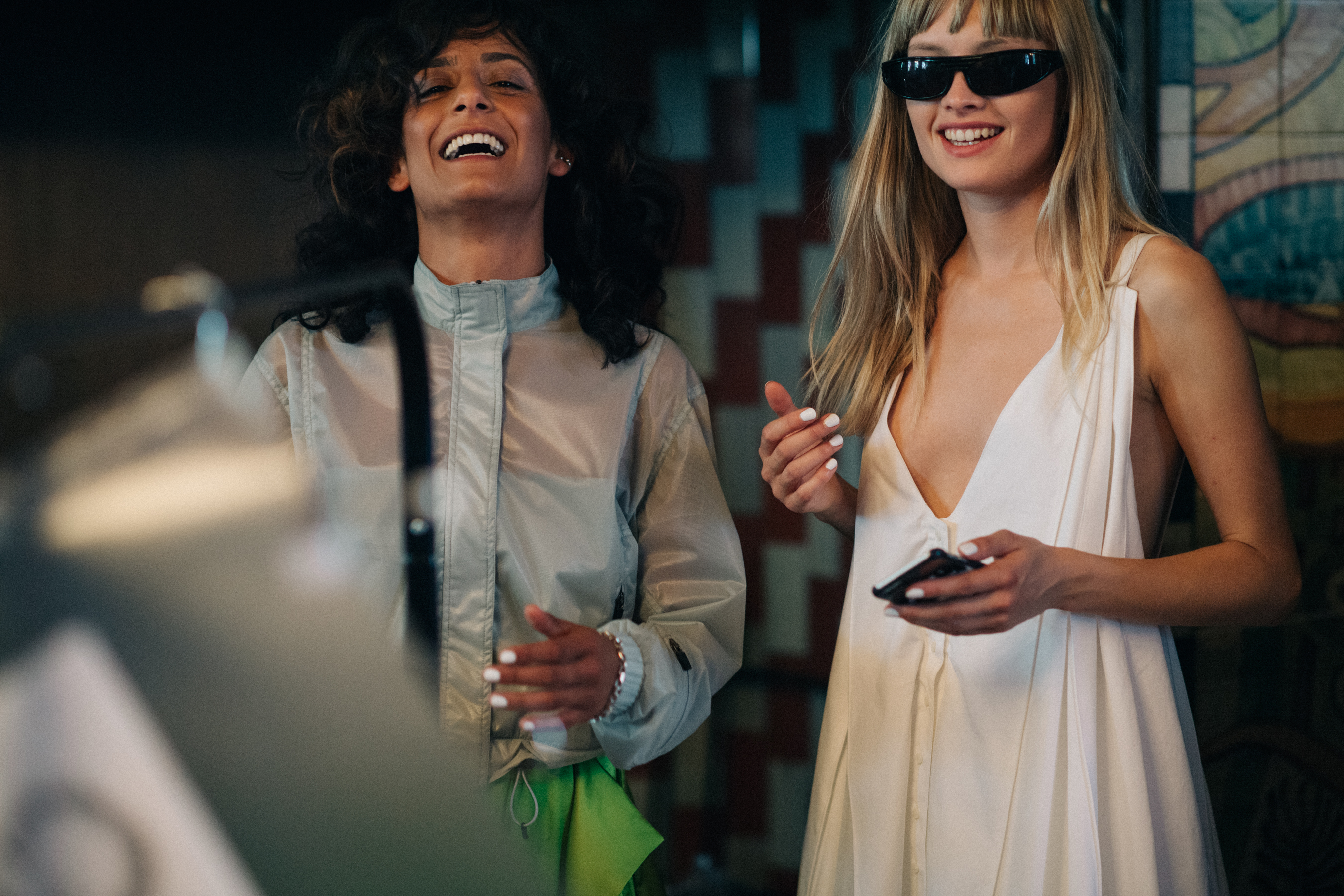 Two models laughing before the show