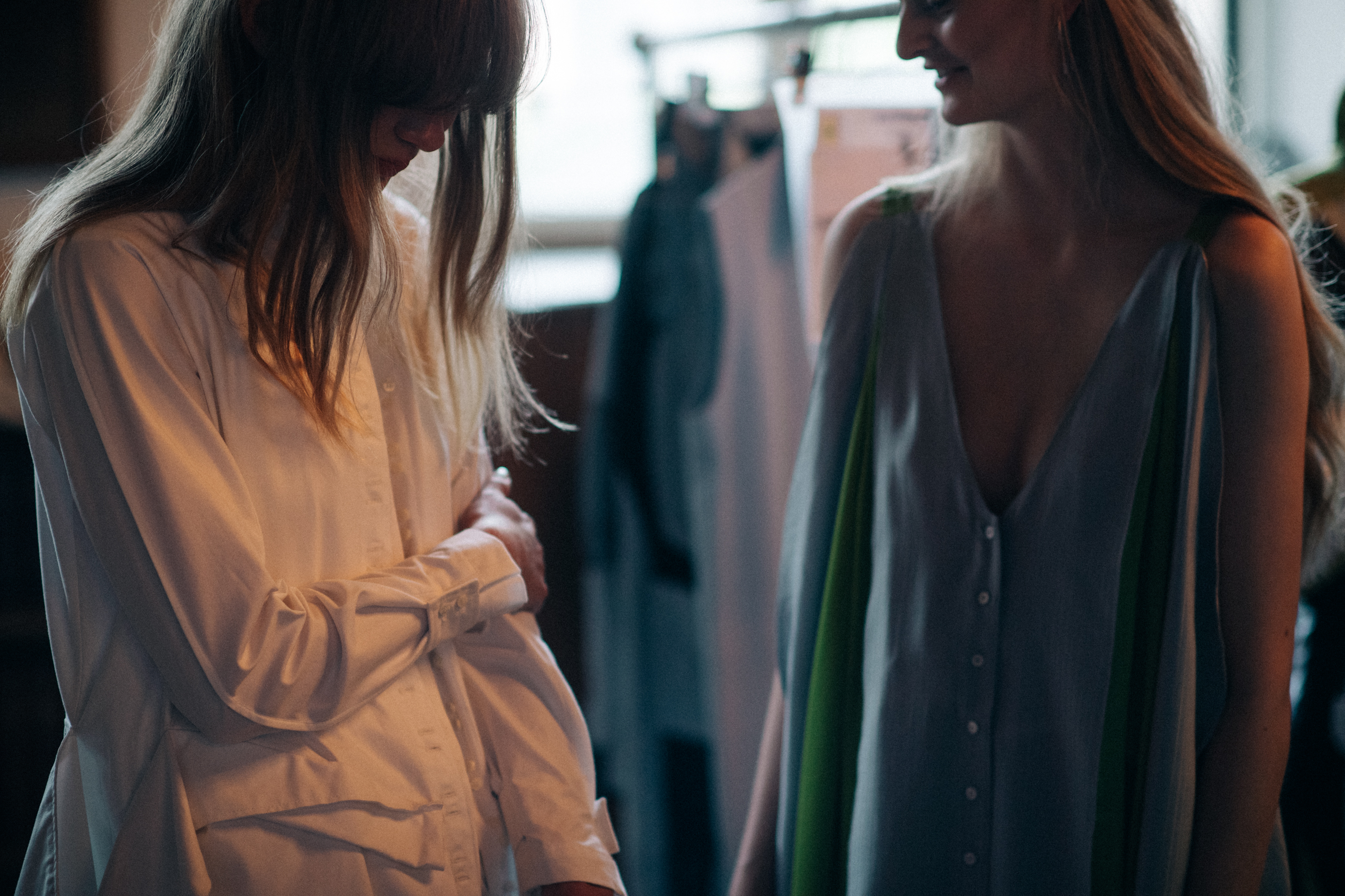 Two models wearing light dresses
