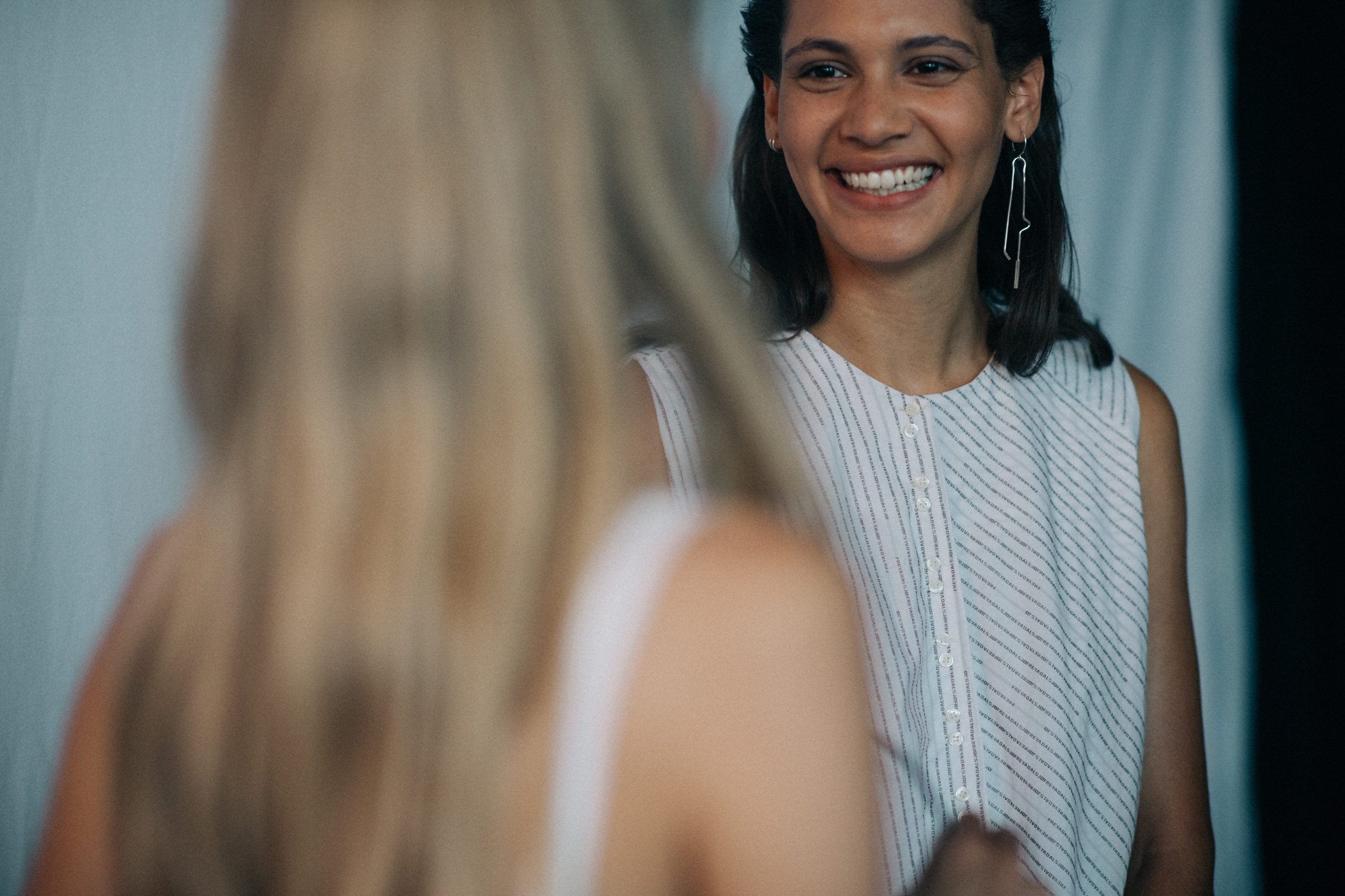 Two models laughing before the show