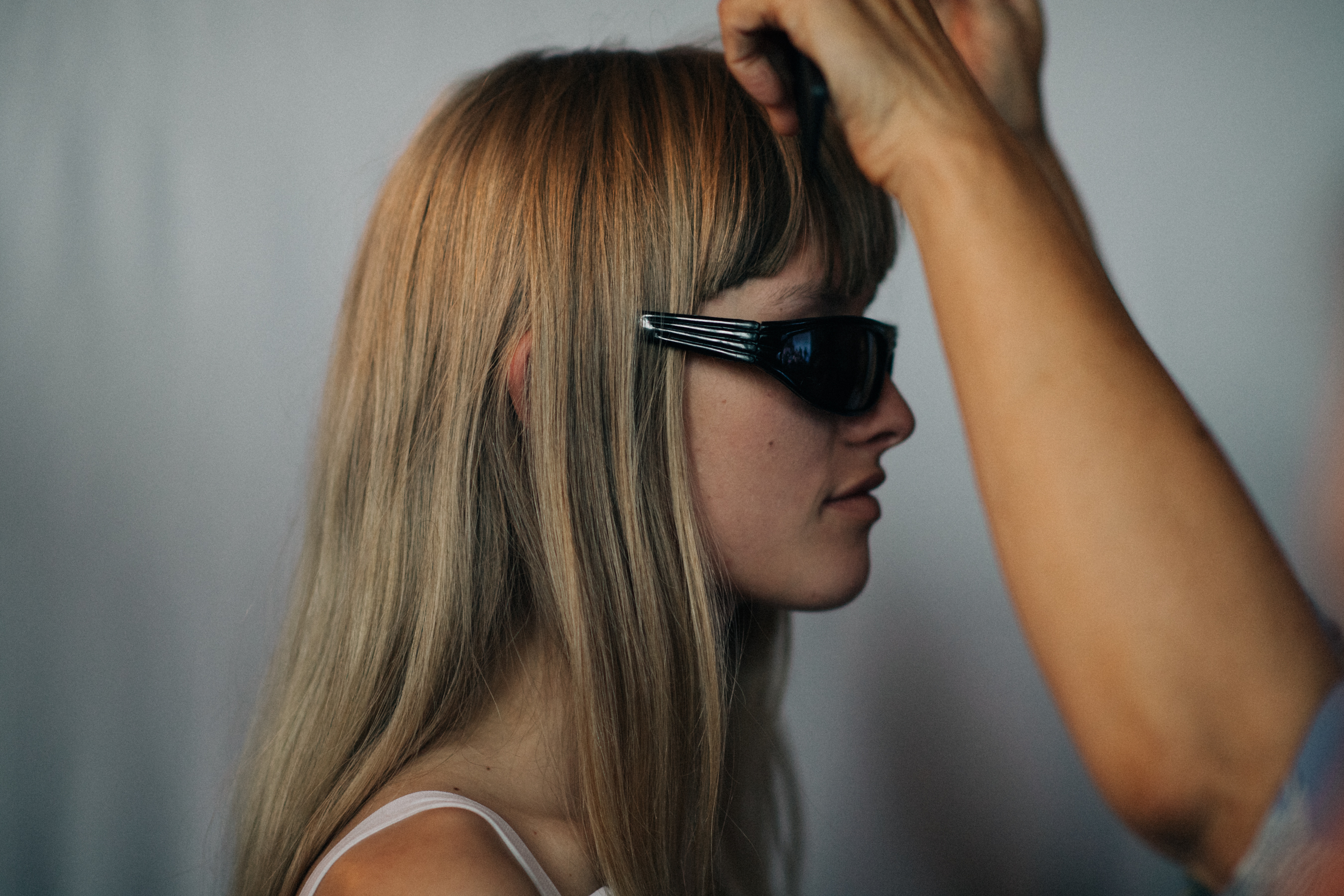 Model with bangs getting hair done