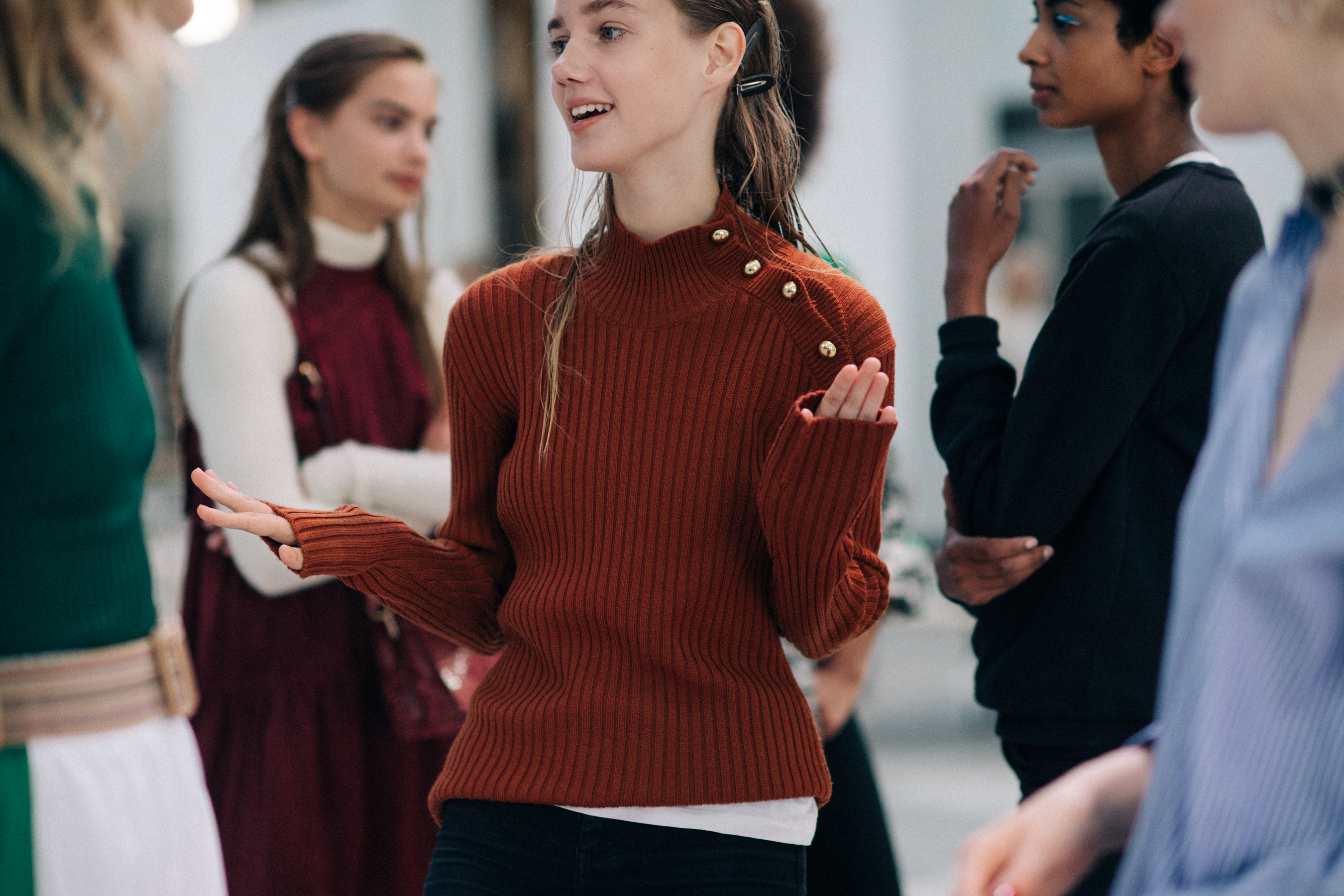 Model wearing brown sweater