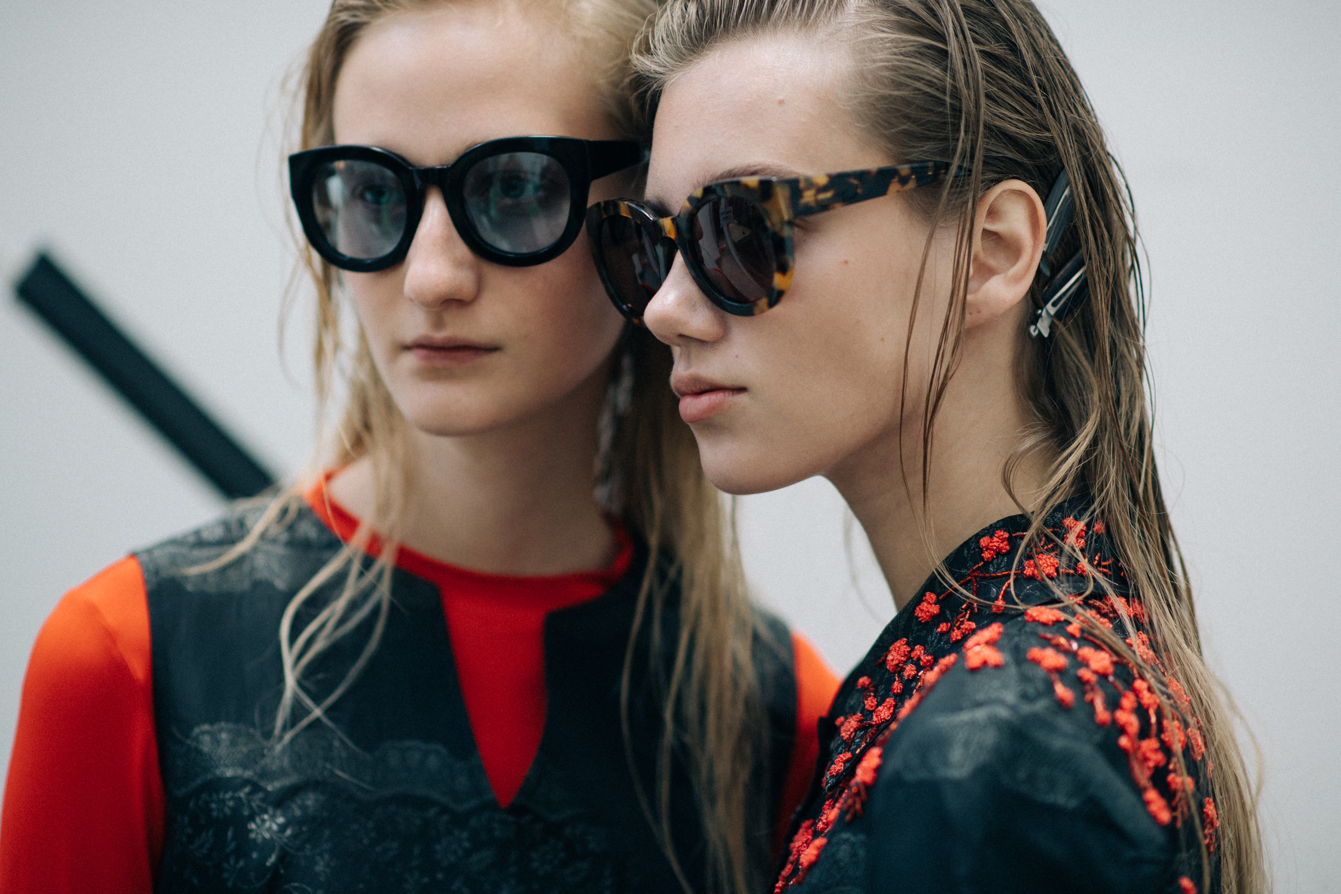 Two models wearing big glasses
