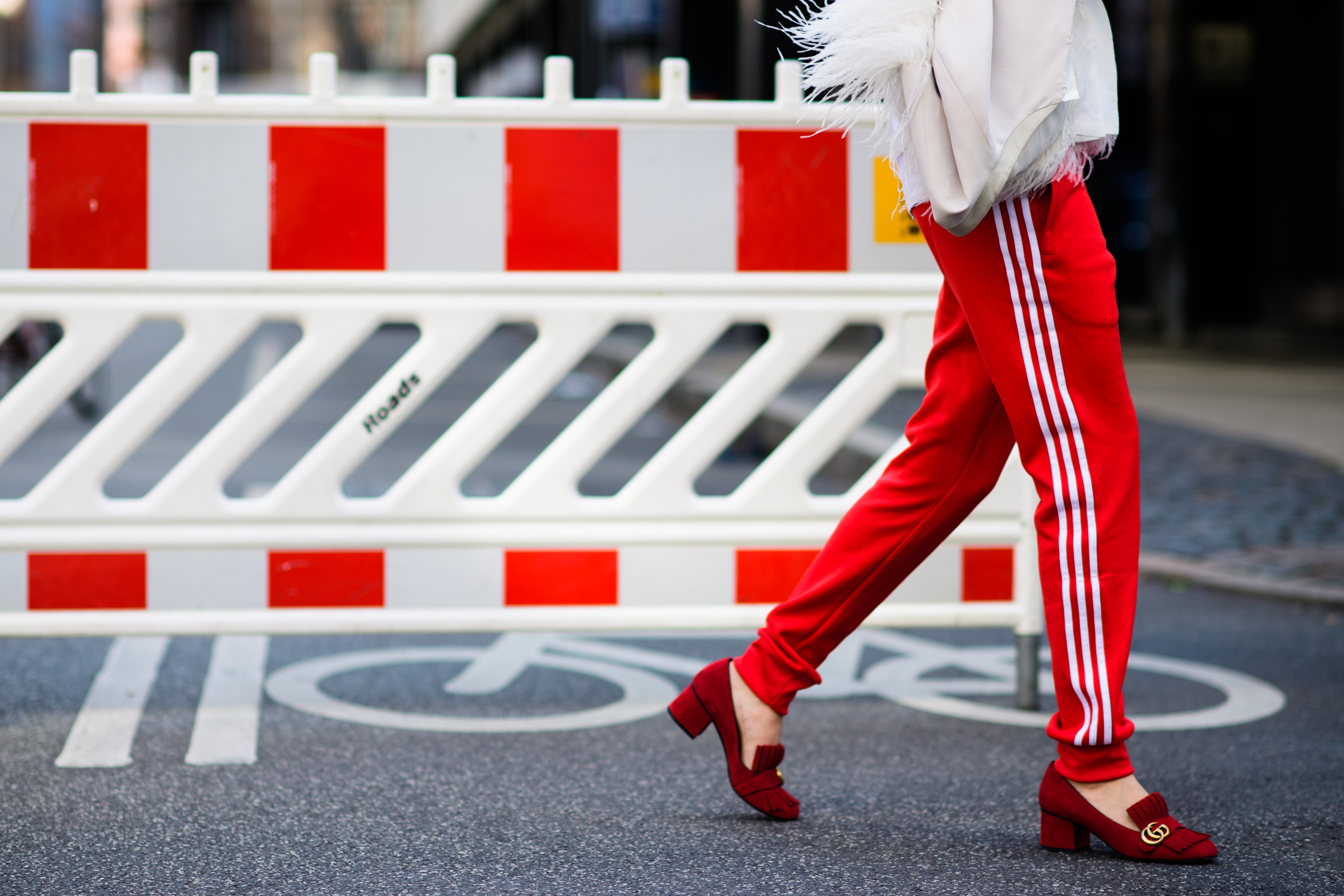Woman wearing adidas track pants