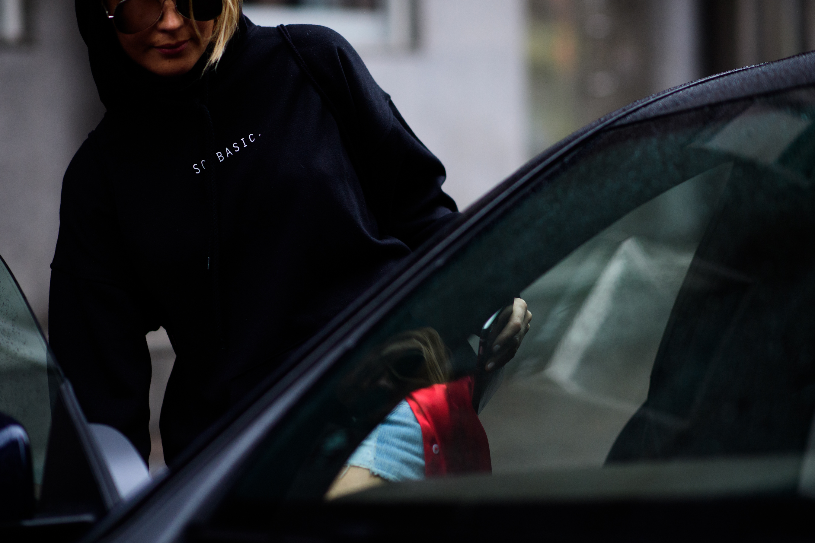 Woman in black getting in the car