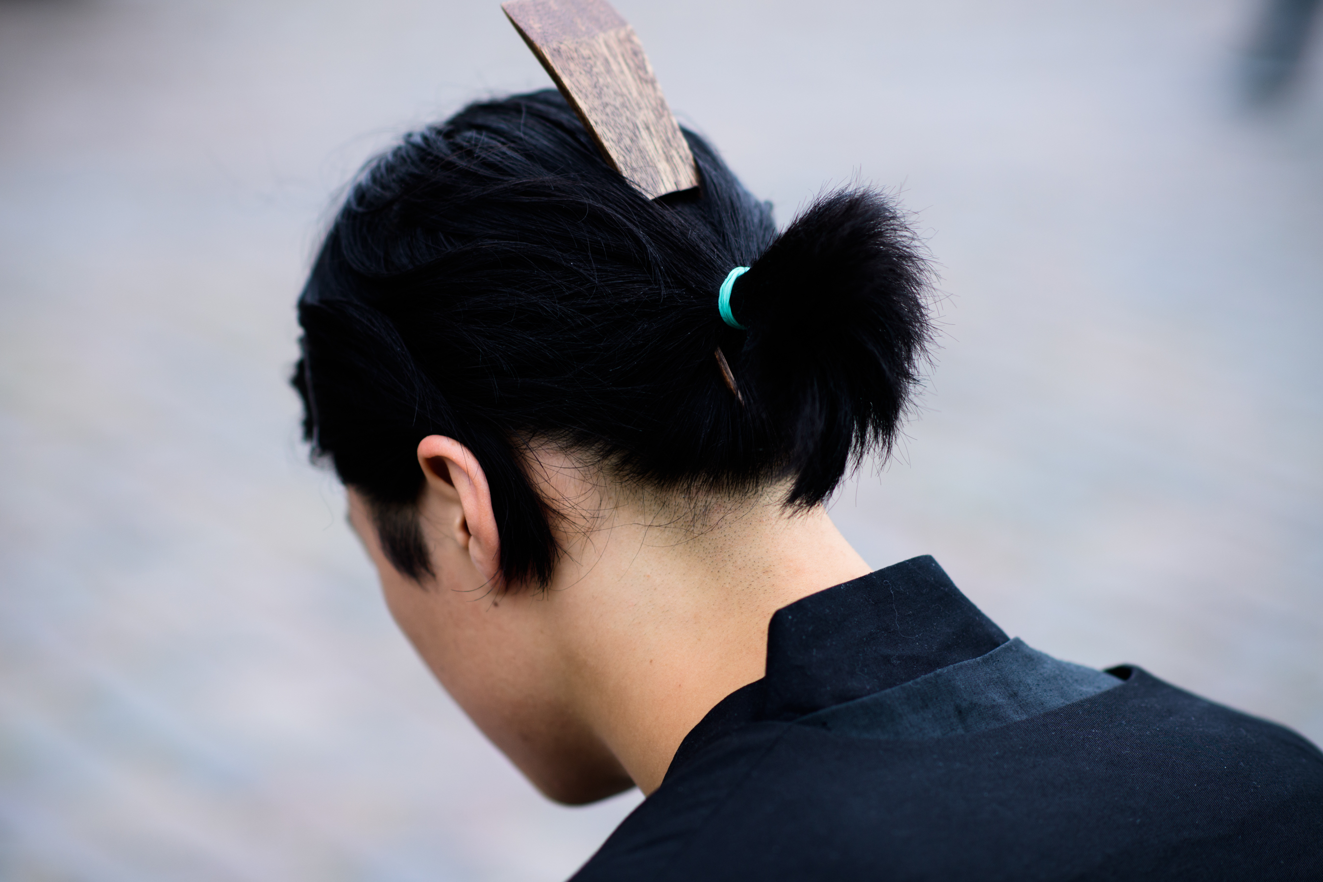 Man with wooden hair piece