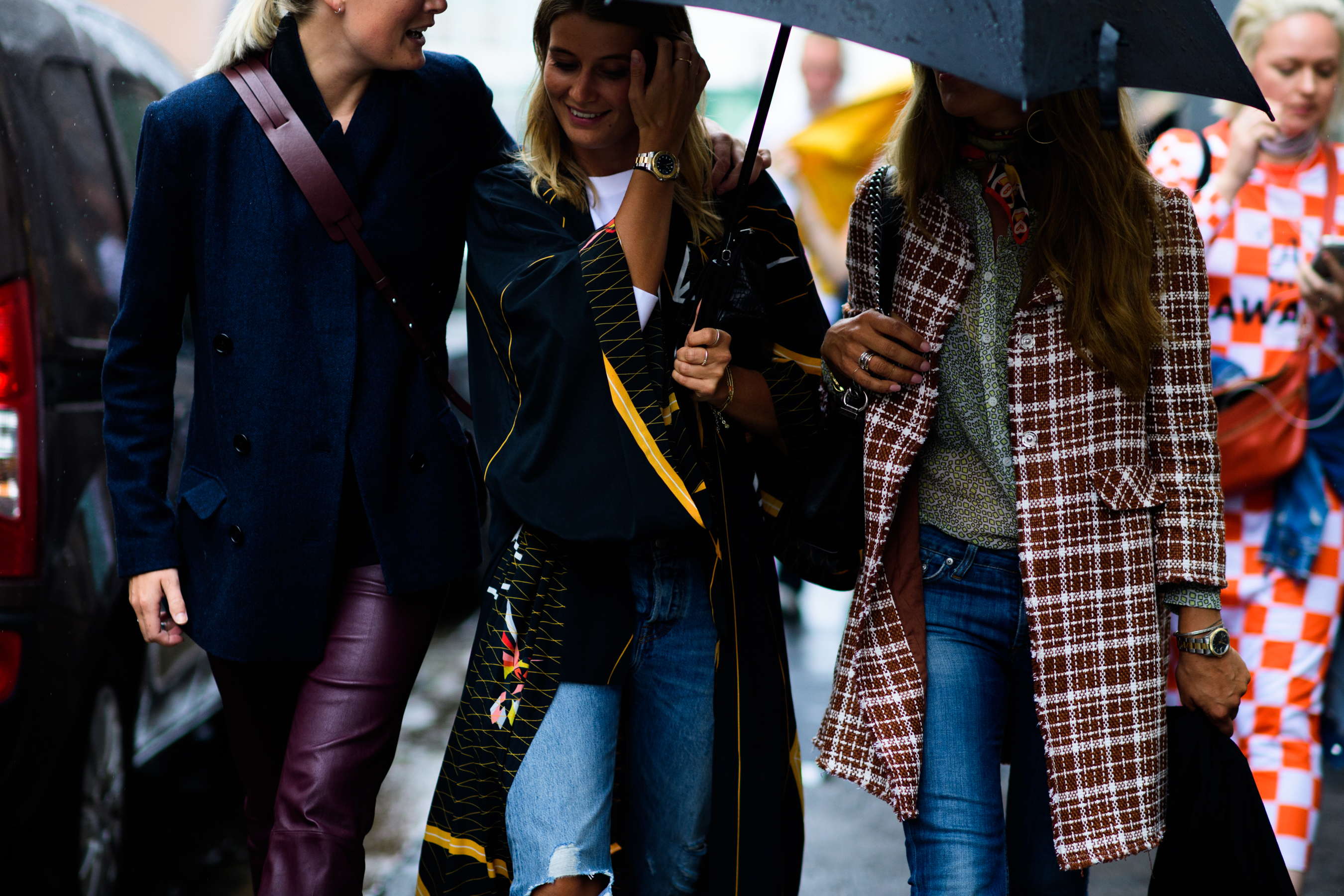Three women wearing coats