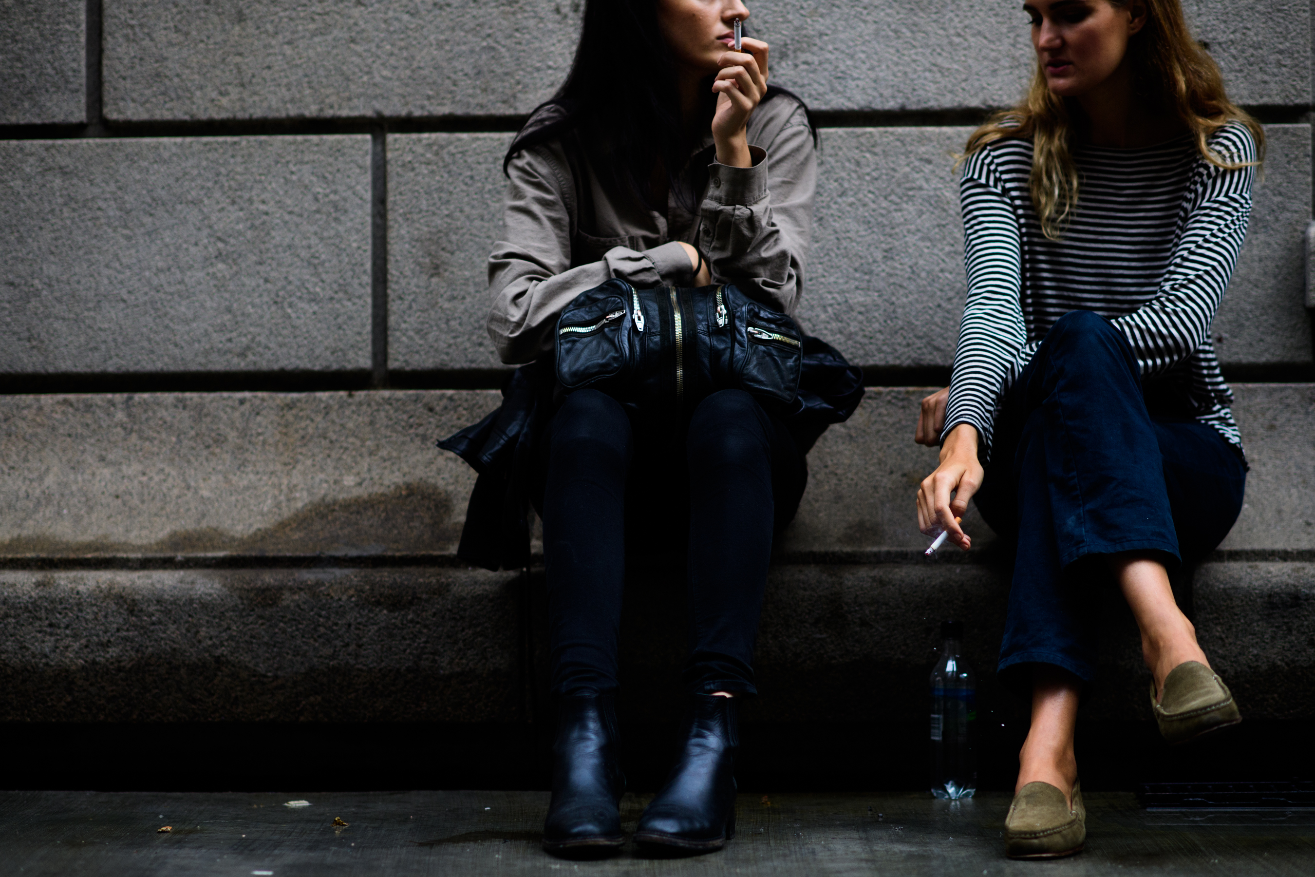 Two models smoking after show