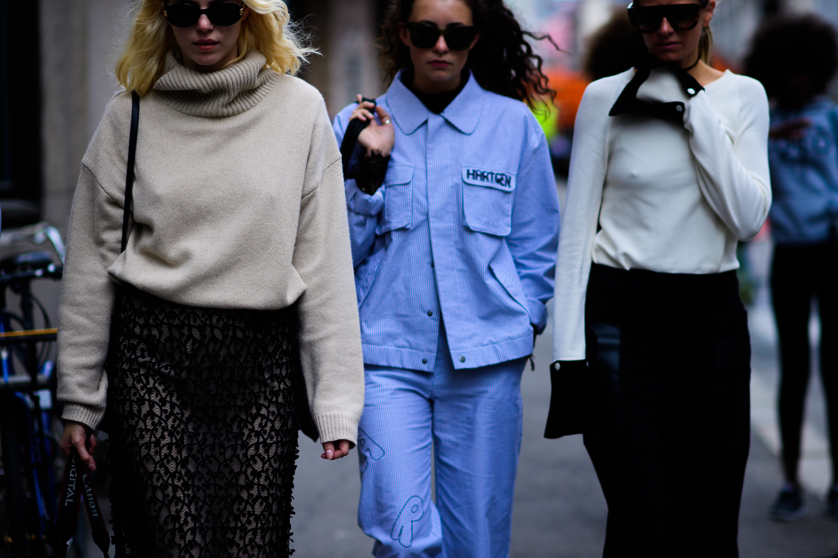Three women wearing beige and blue