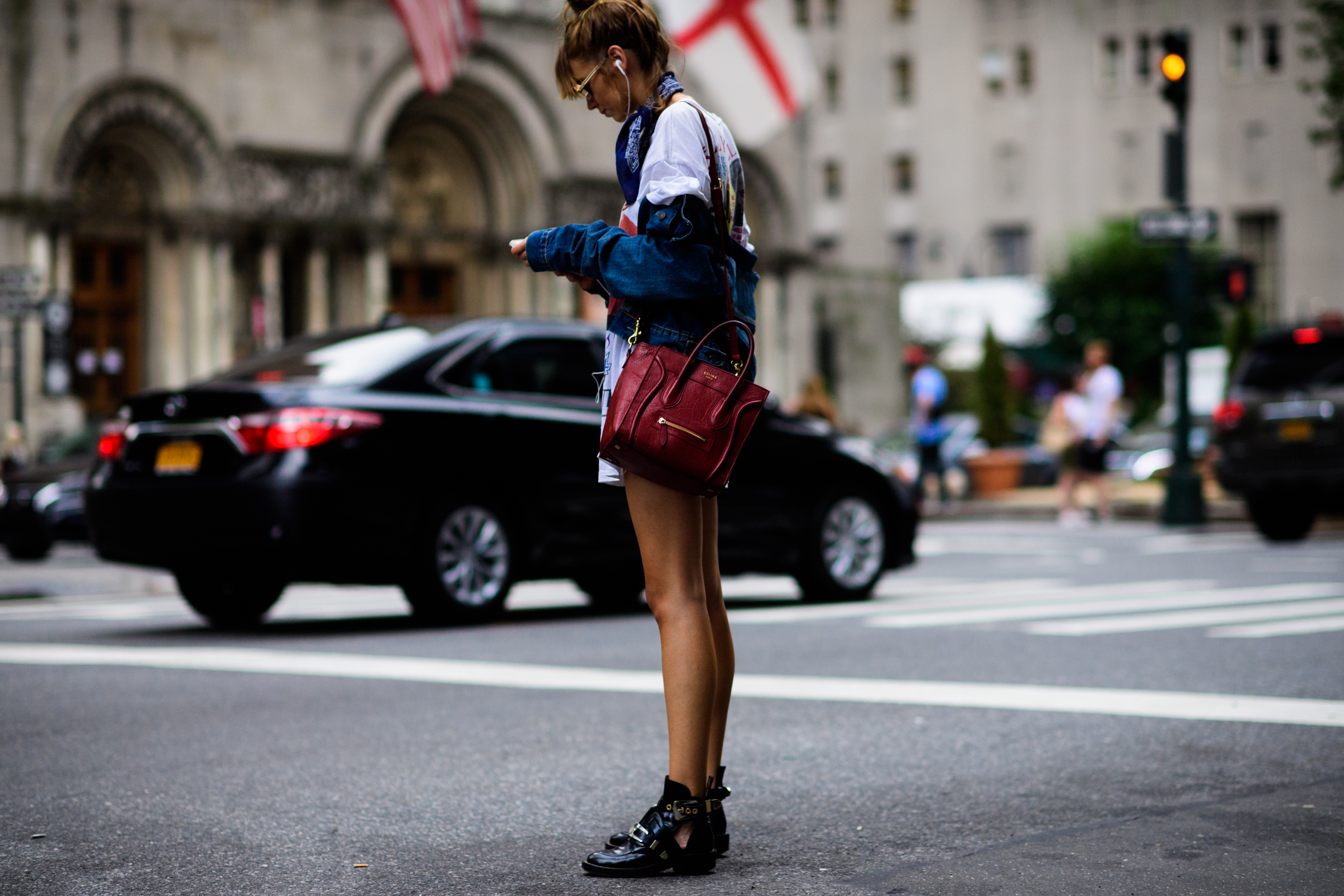 Model with red bag and Balenciaga boots