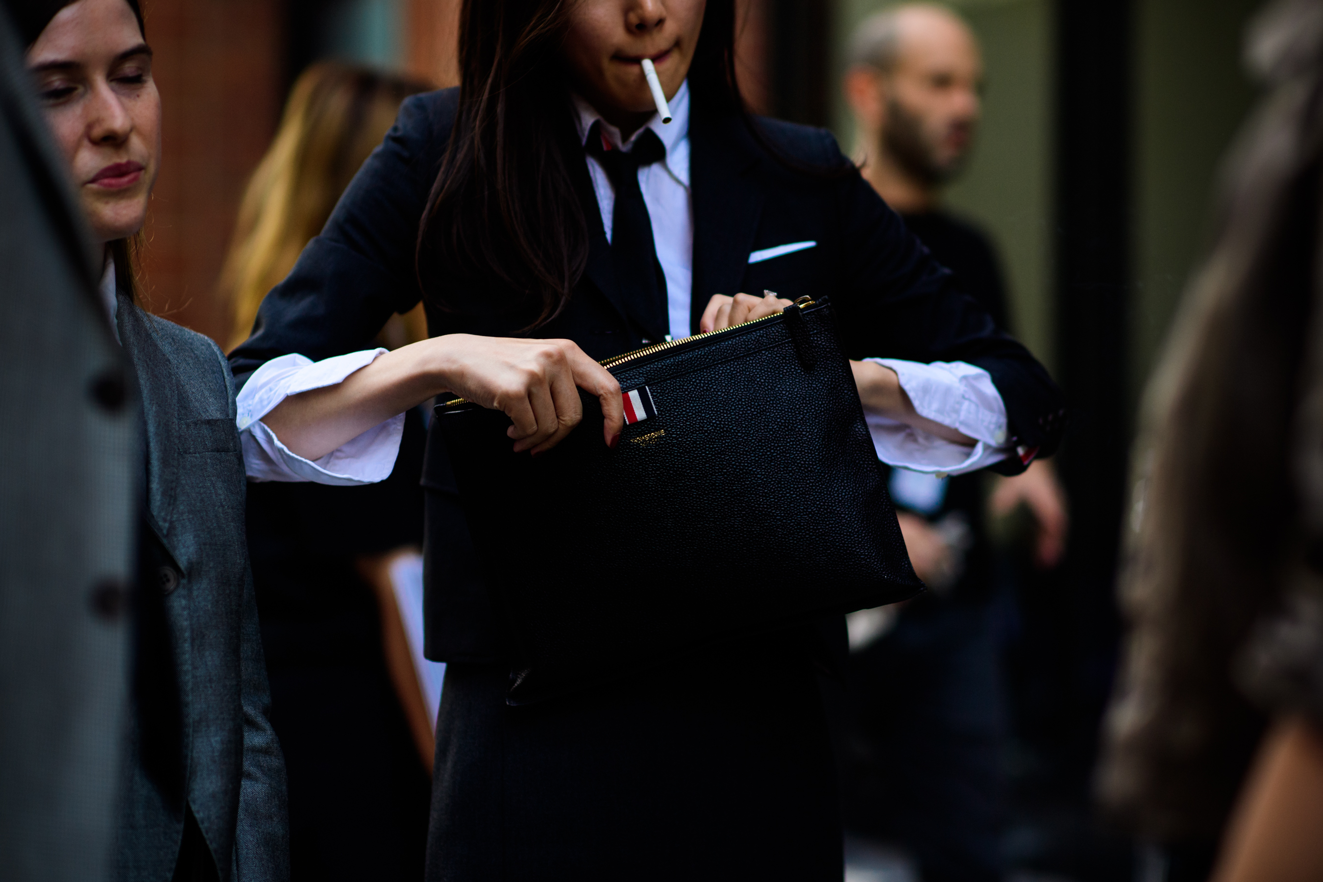 Woman holding black clutch bag