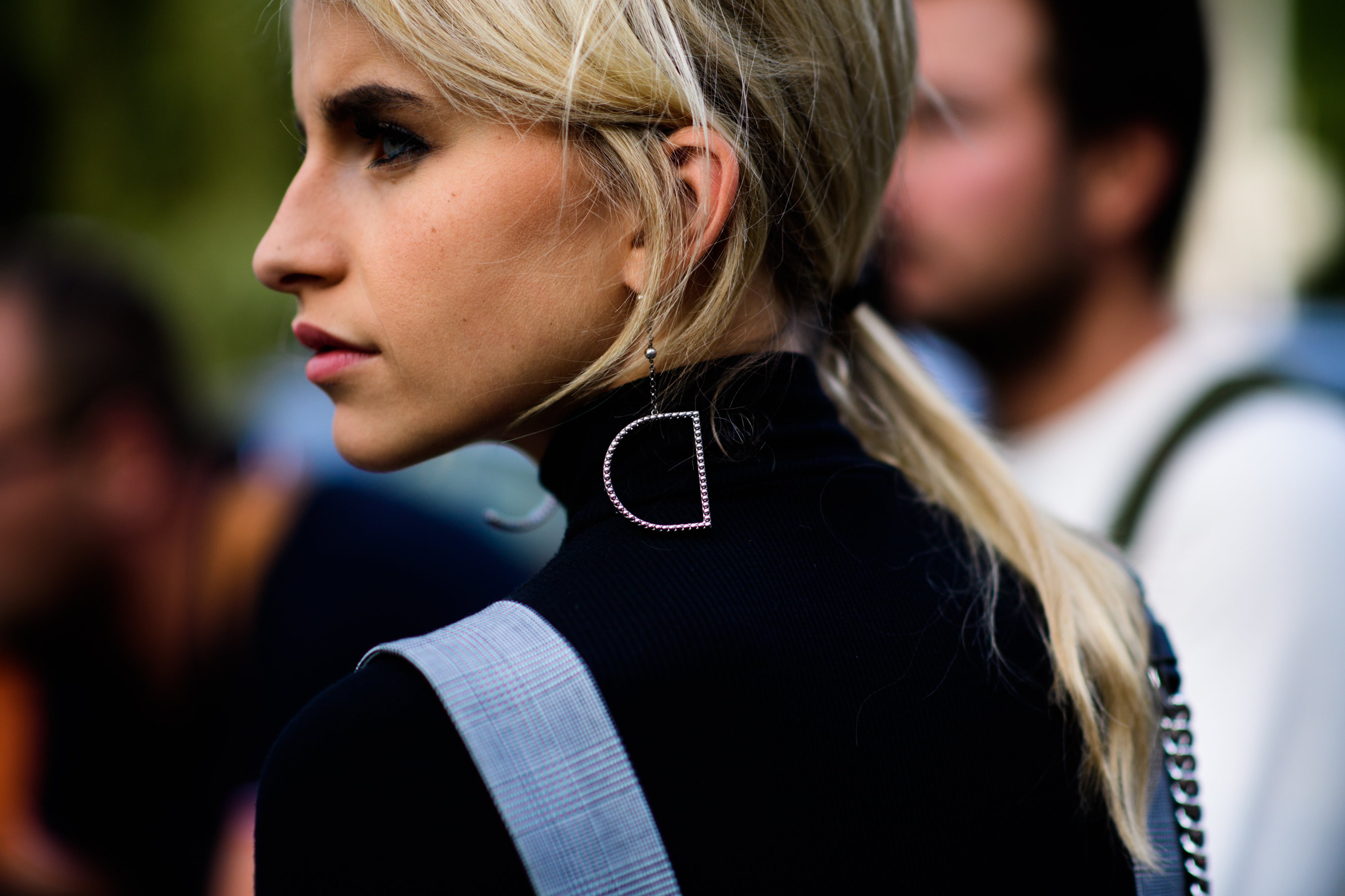 Woman wearing D shaped earring