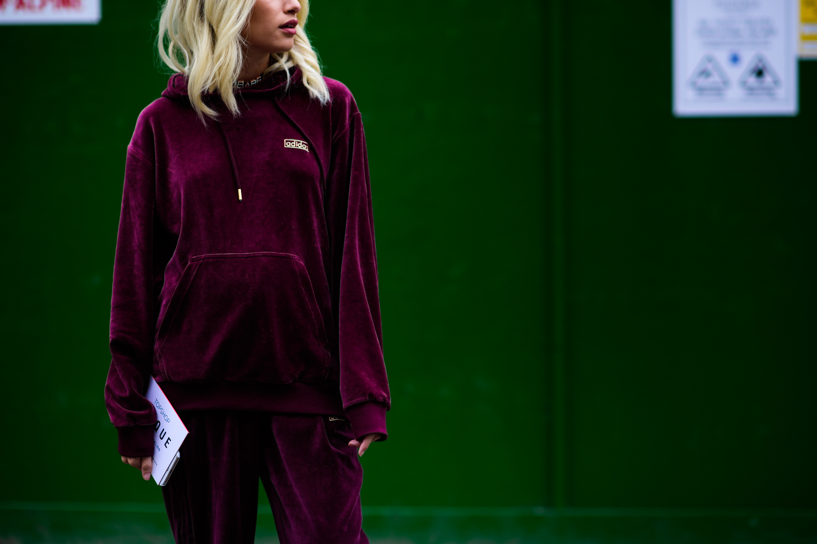Woman wearing velvet Adidas sportsuit