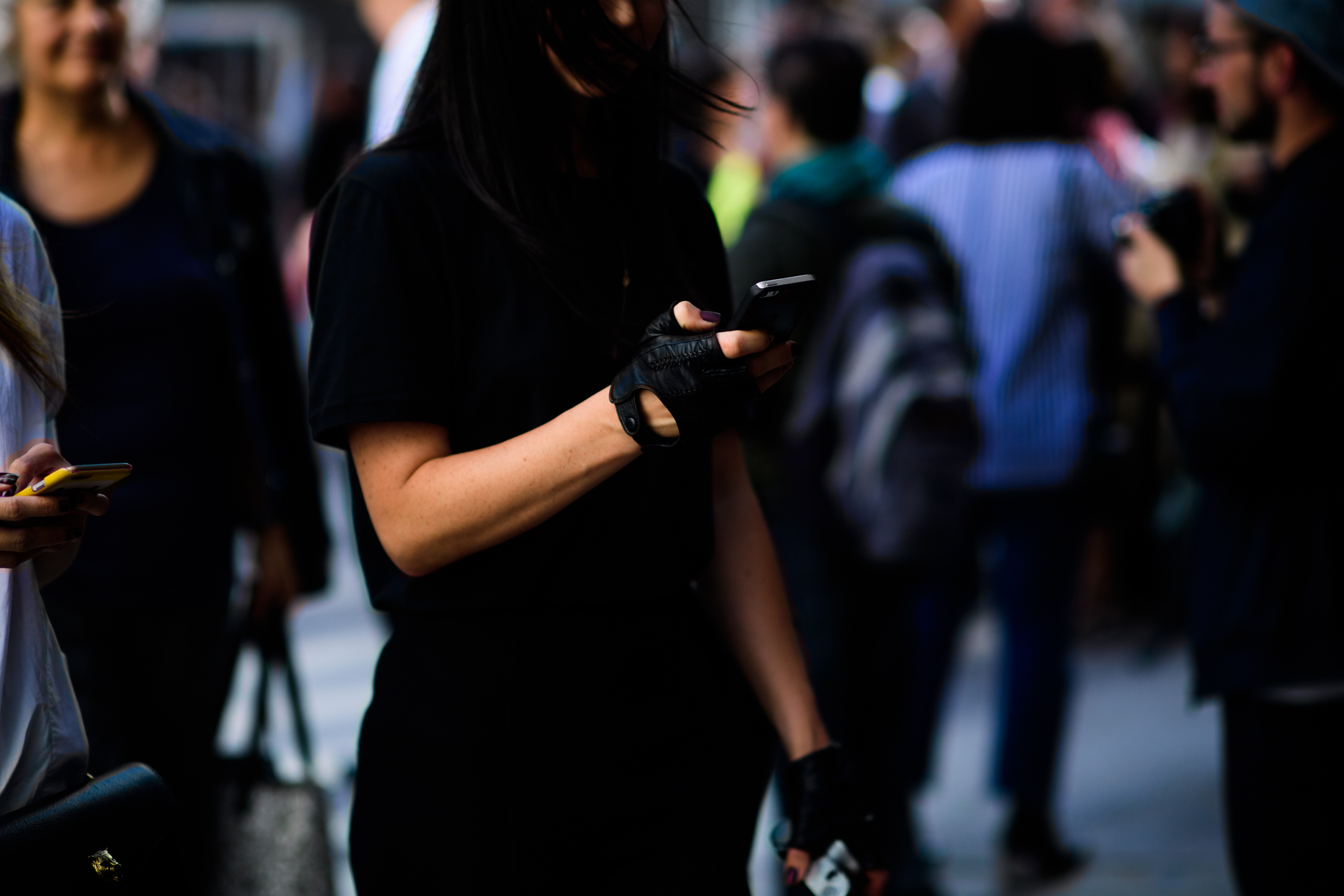Woman wearing black biker gloves