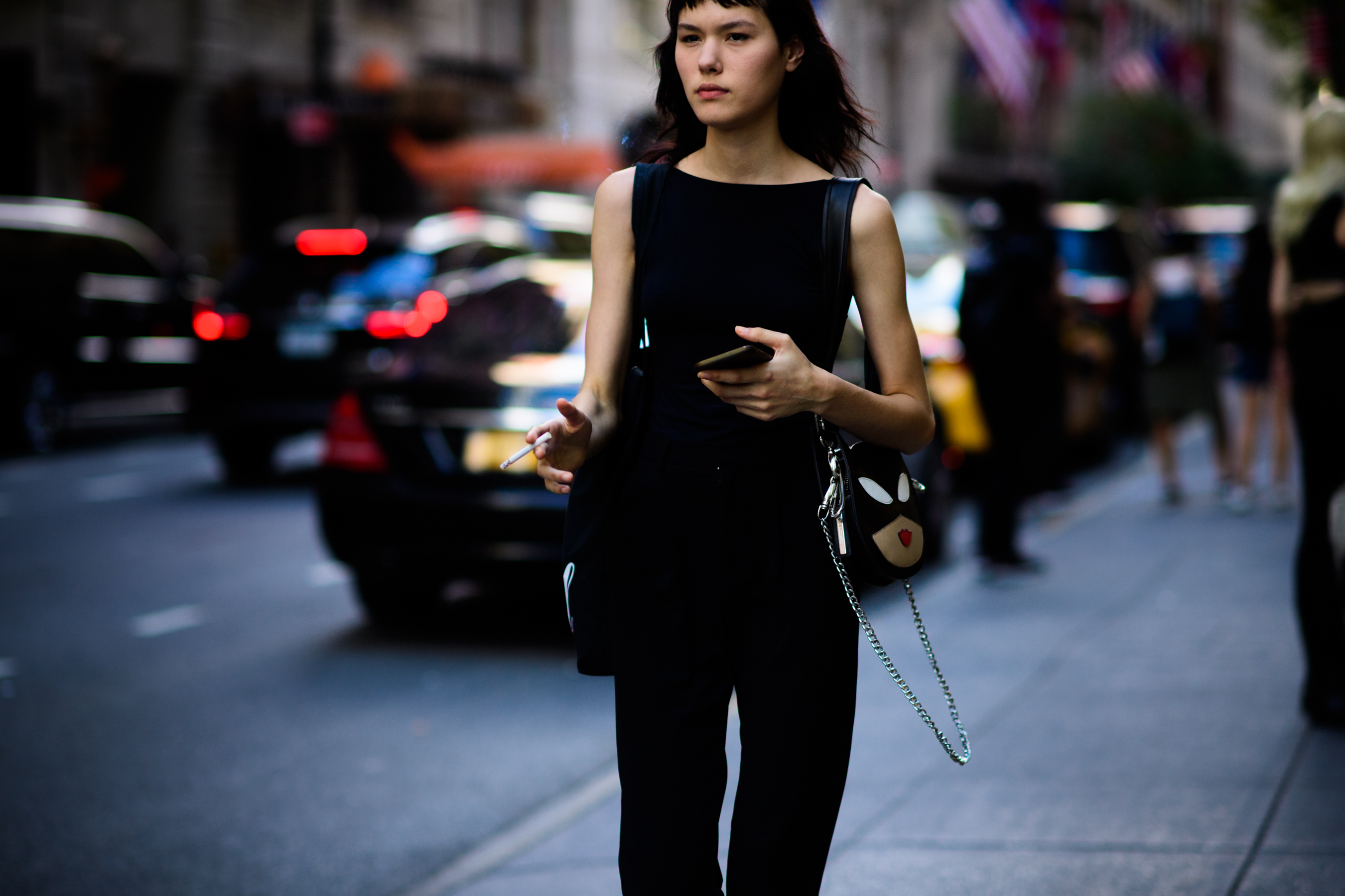 Model with dark hair and Batman bag