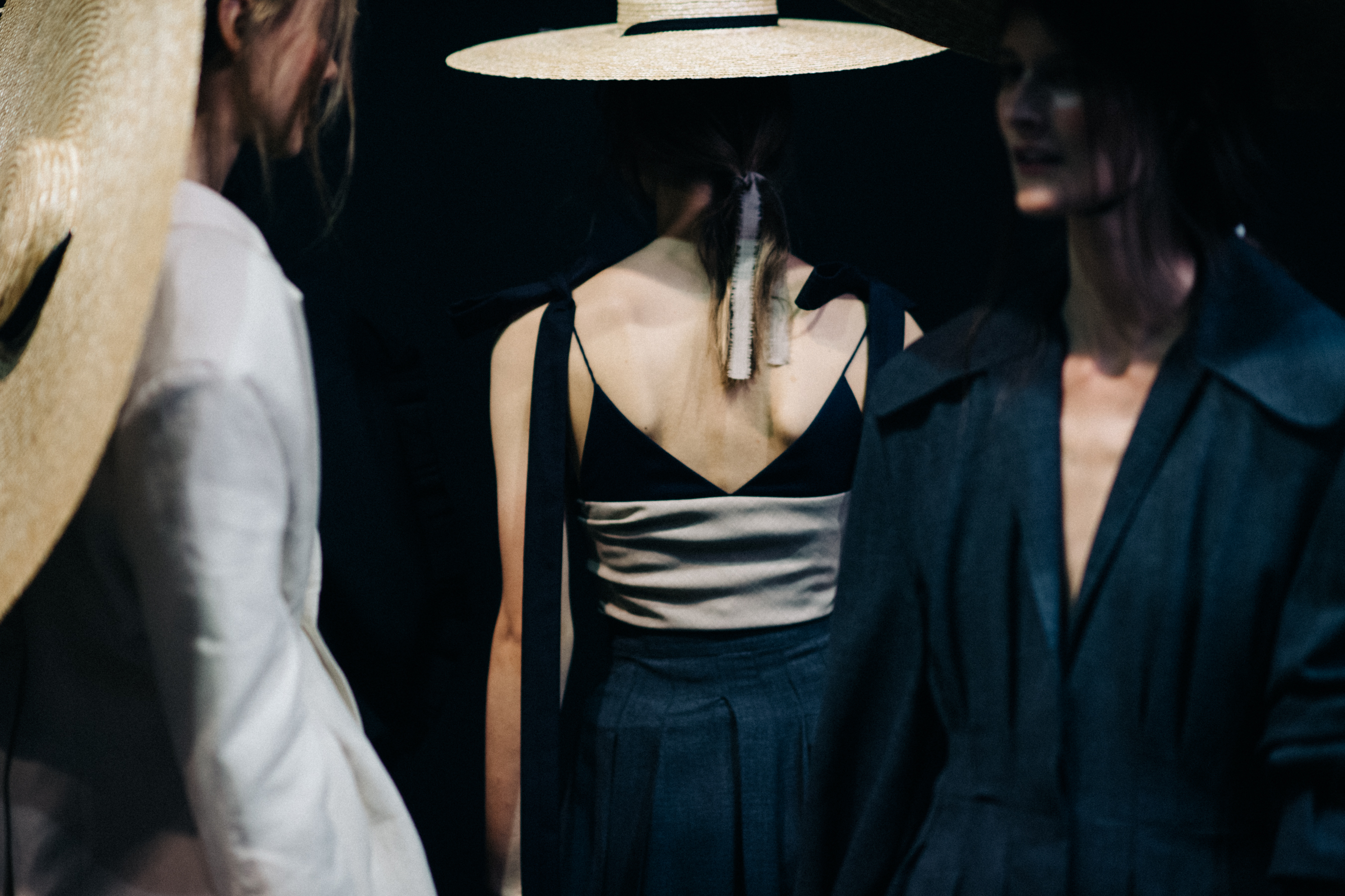 Model wearing oversized straw hat