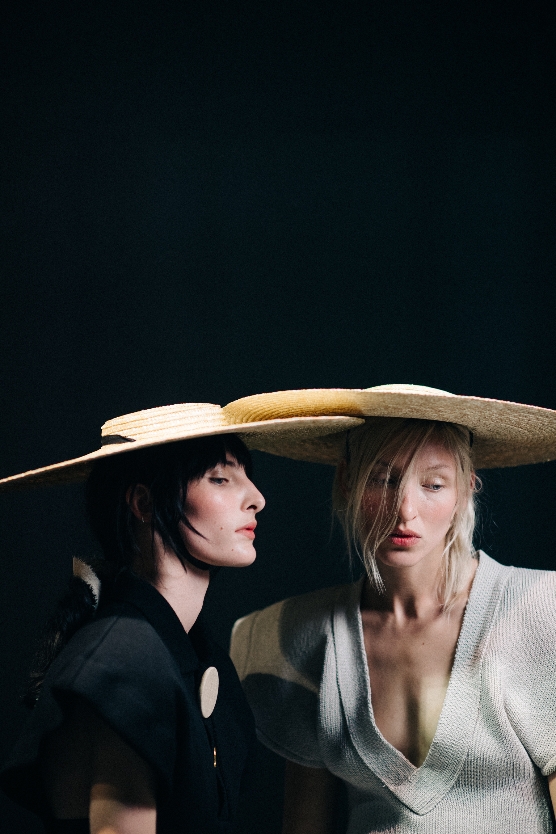 Models wearing oversized straw hat