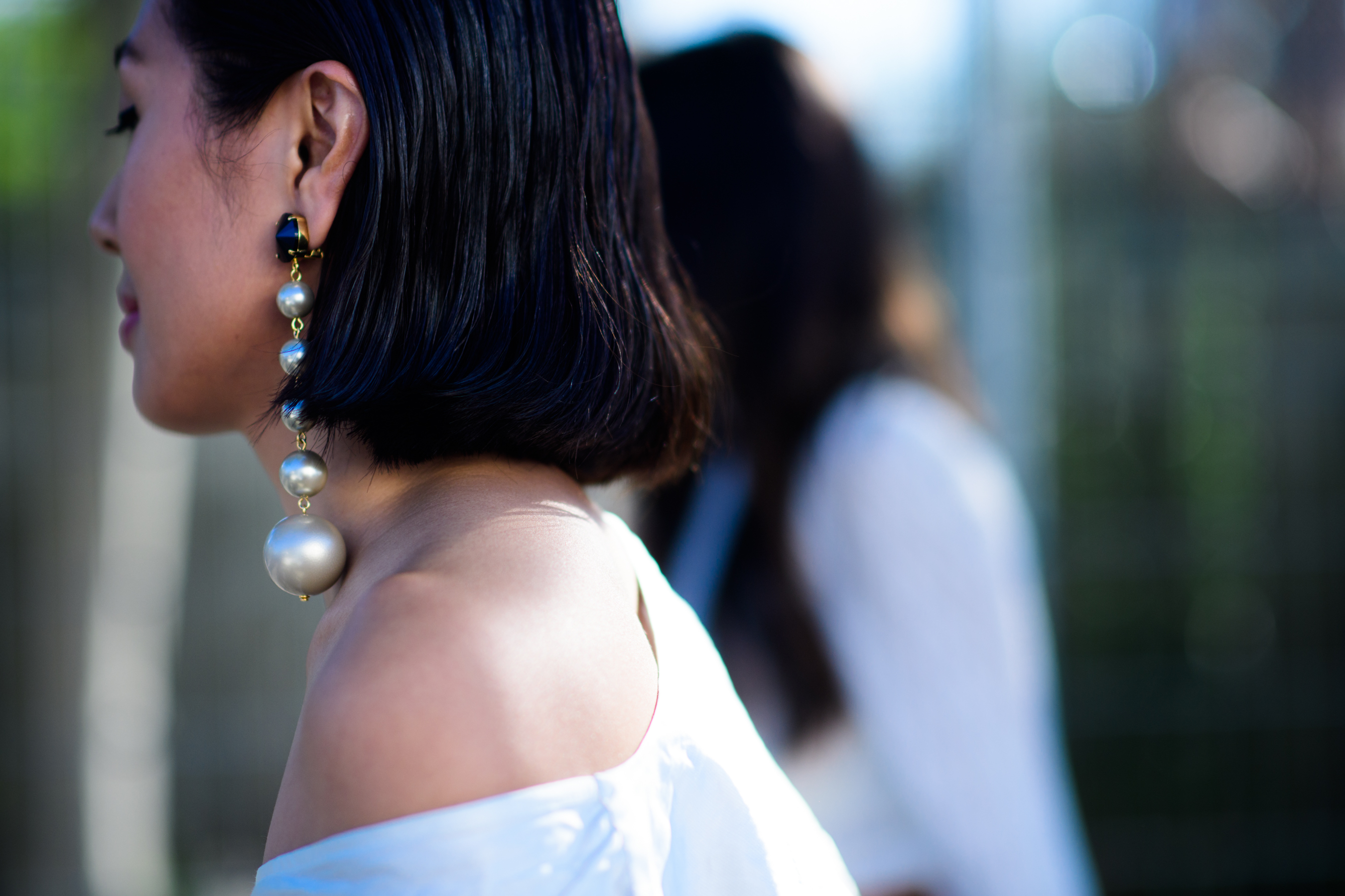 Woman wearing massive pearl earring