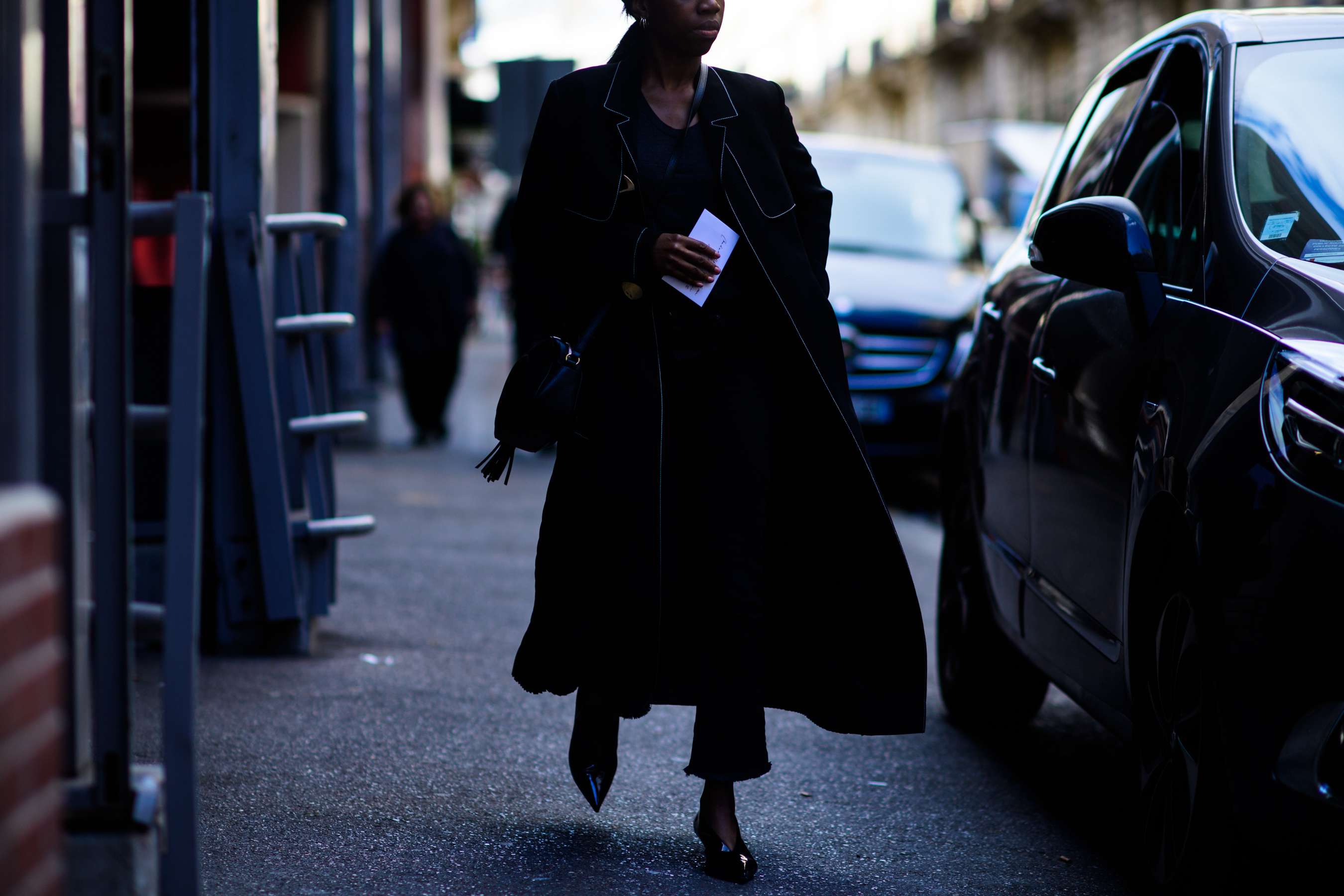 Woman wearing long black coat