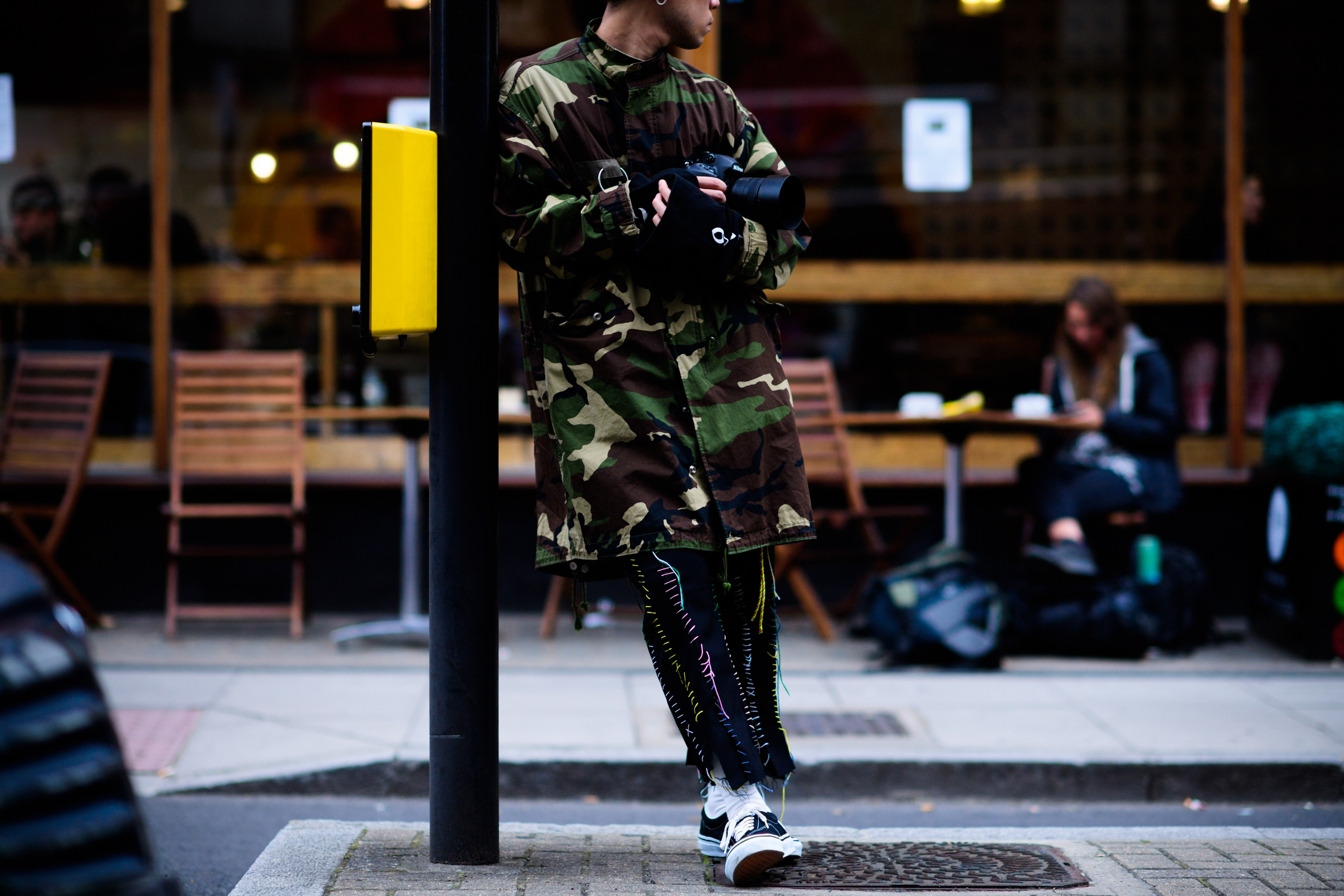 Japanese photographer wearing stitched pants