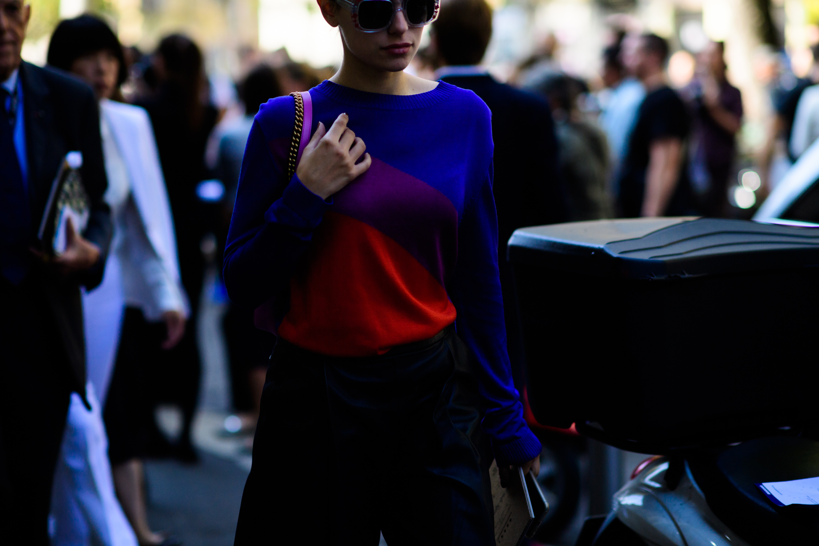 Woman wearing blue and red sweater