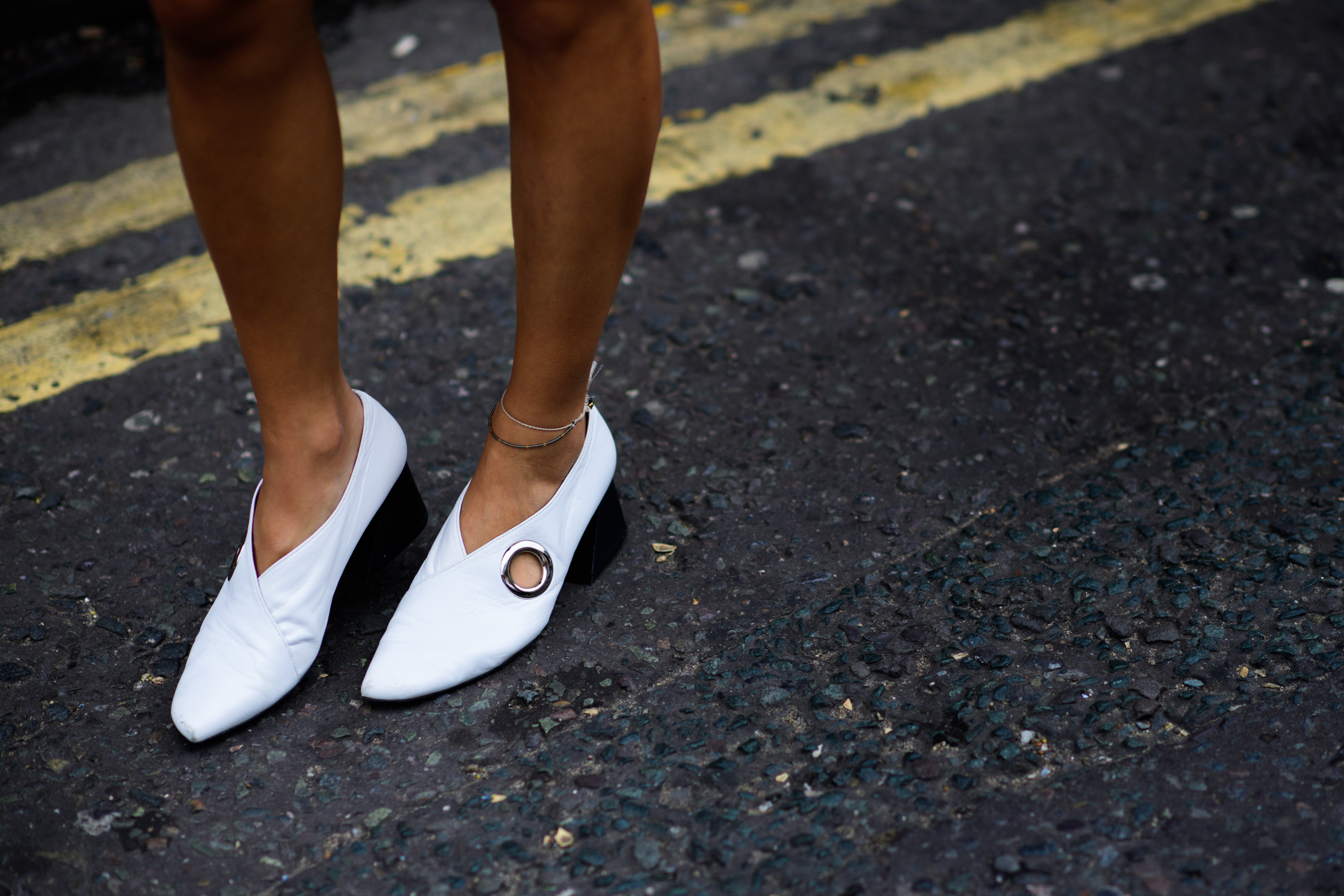 Woman wearing white perforated shoes