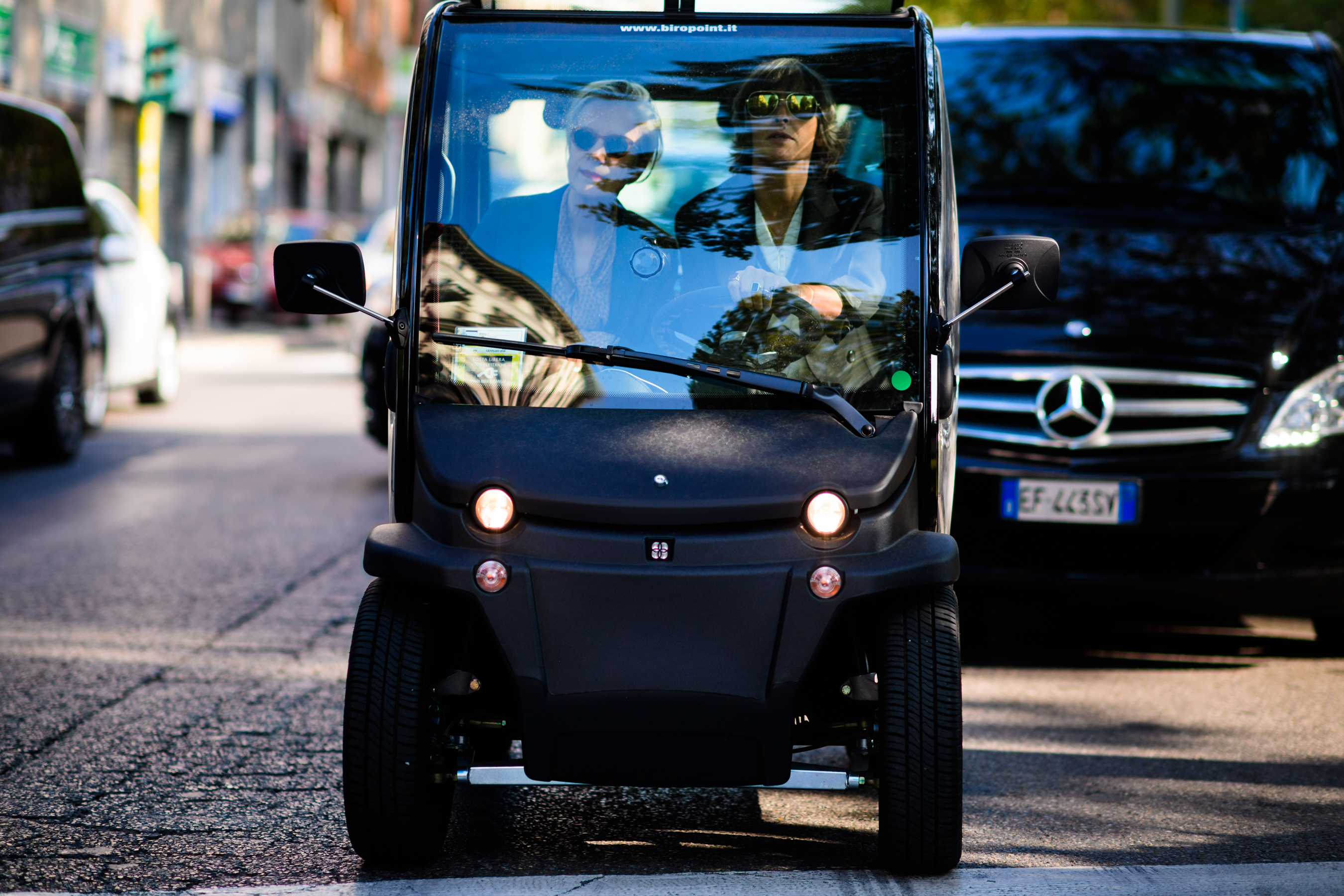 Two Italian women in transparent mini car