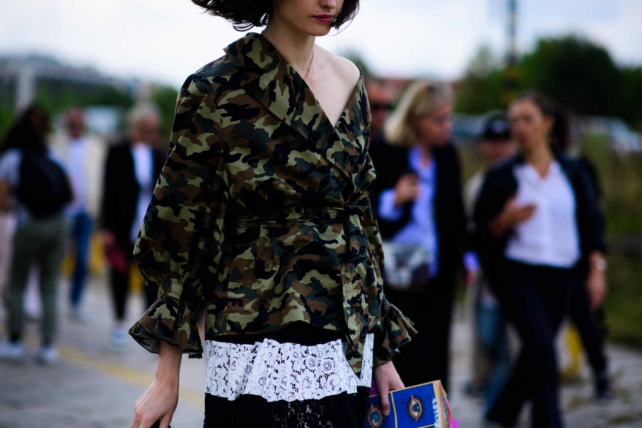 Girl wearing one shoulder camo jacket