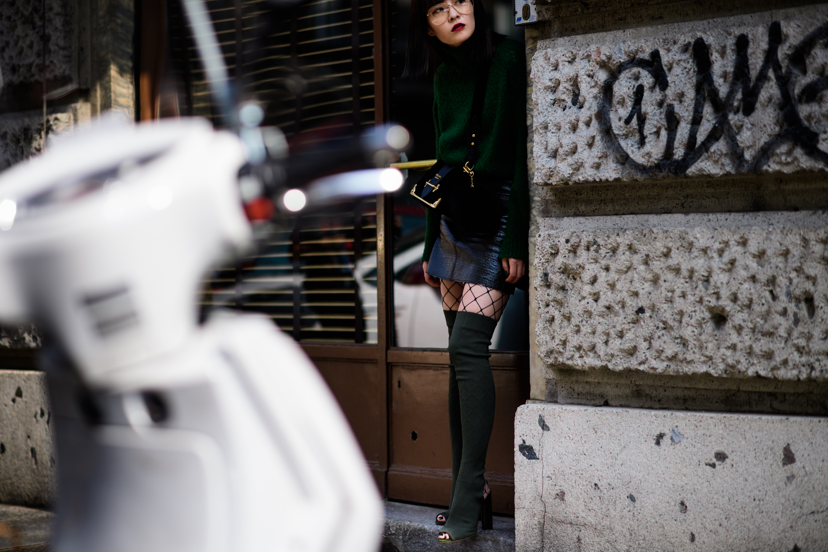 Woman wearing tall green boots